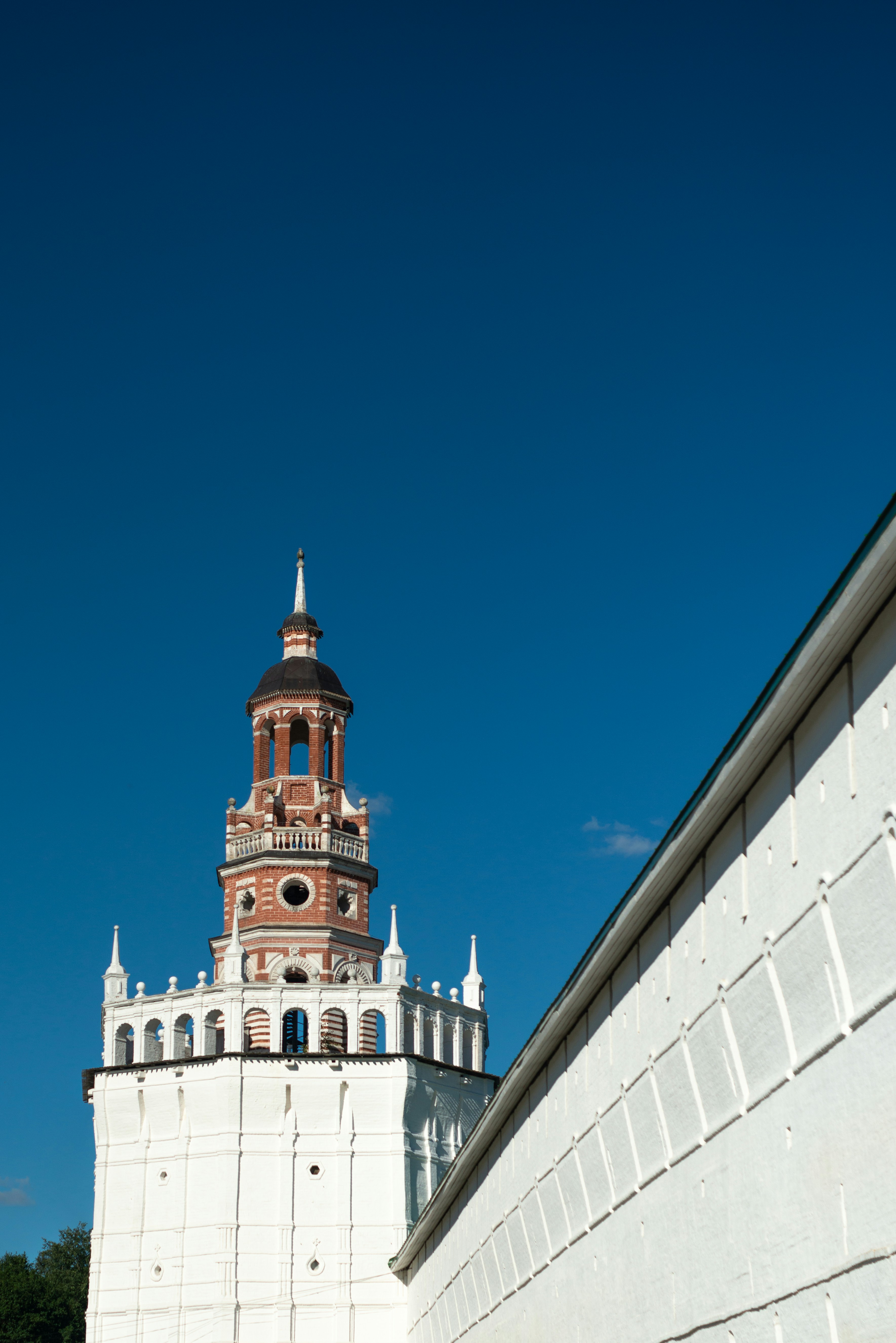A tall tower with a clock on the top of it