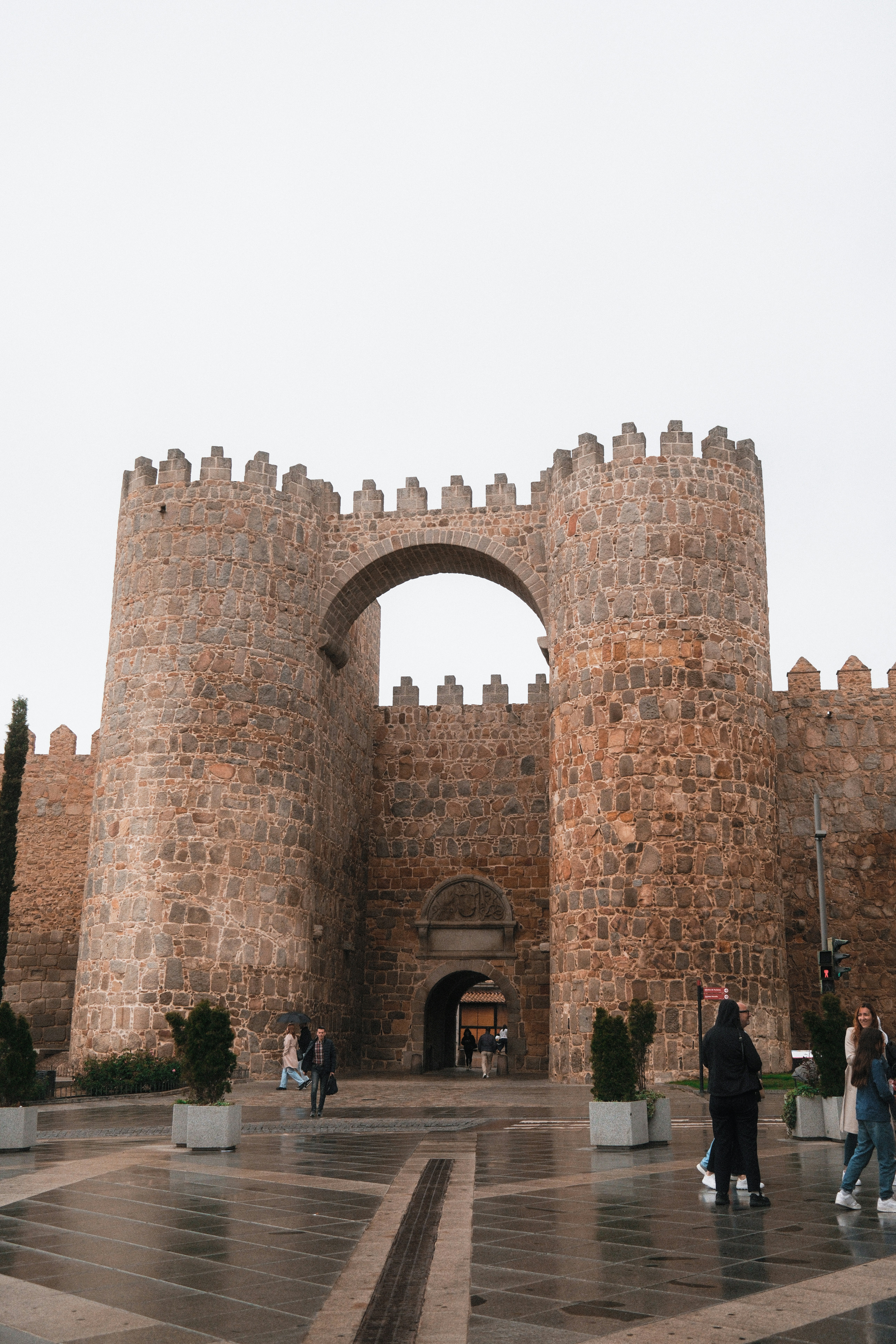 A large brick castle with a gate and steps leading to it