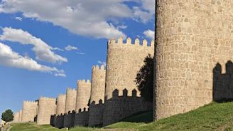 A very tall castle with a clock on it's side