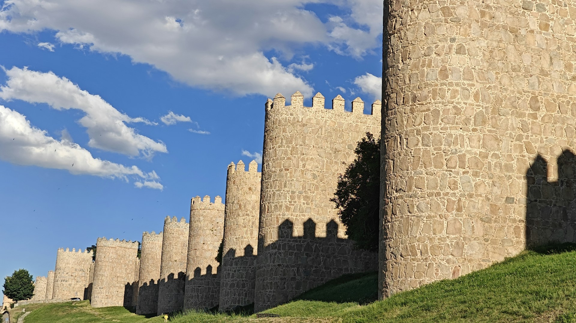 A very tall castle with a clock on it's side