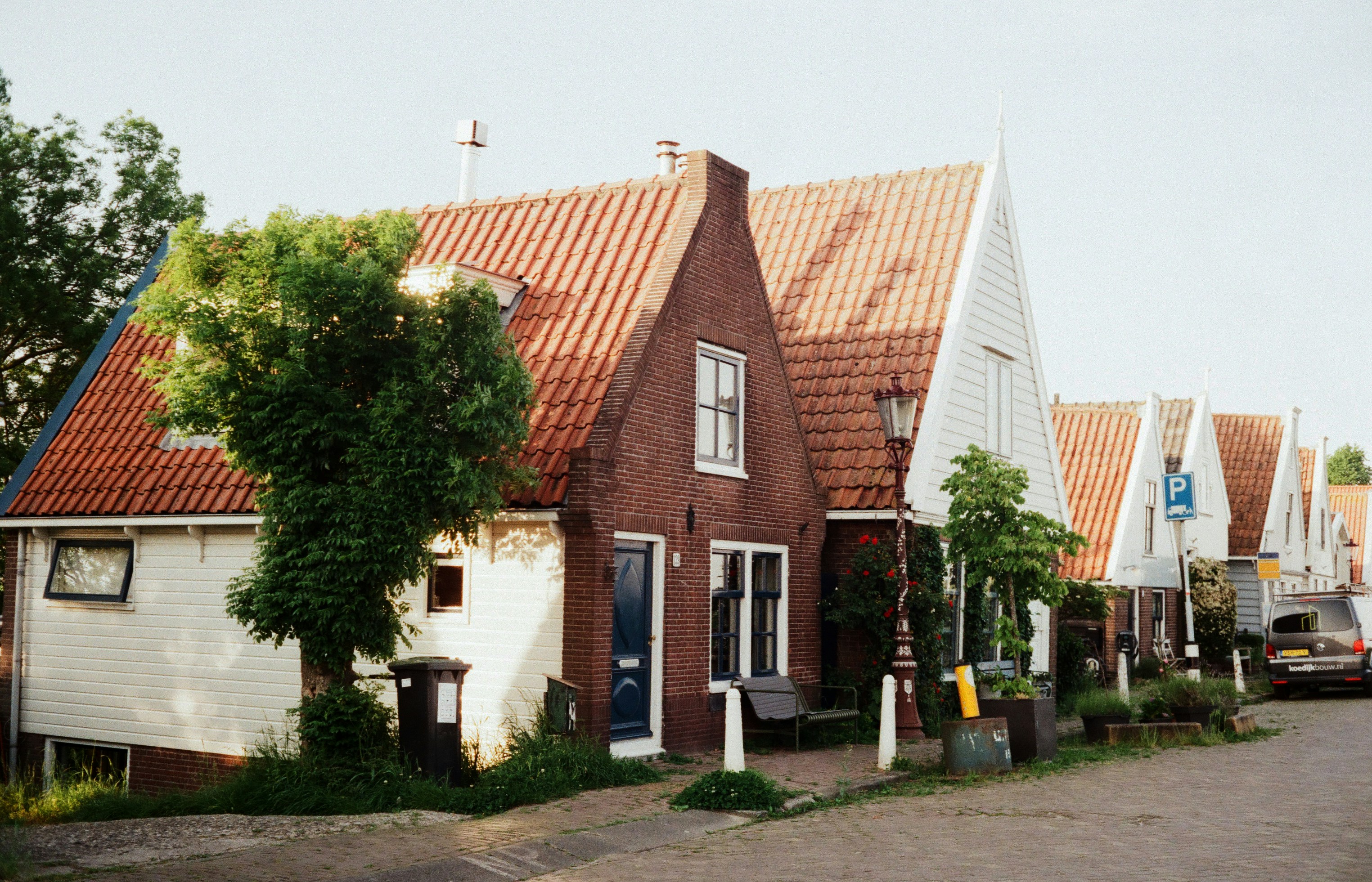 A row of houses with a car parked in front of them