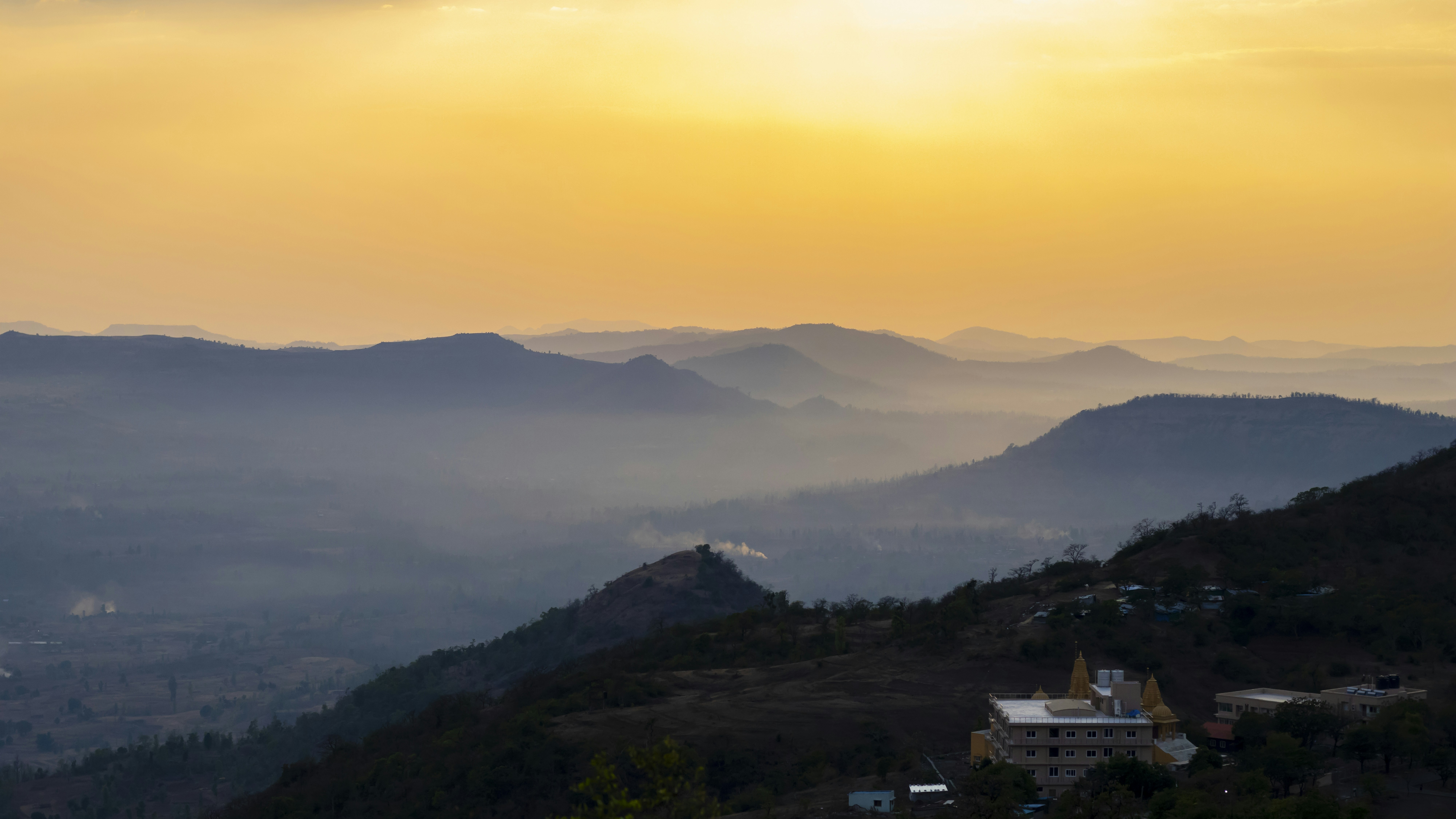 The sun is setting over a mountain range photo Free Gujarat Image on
