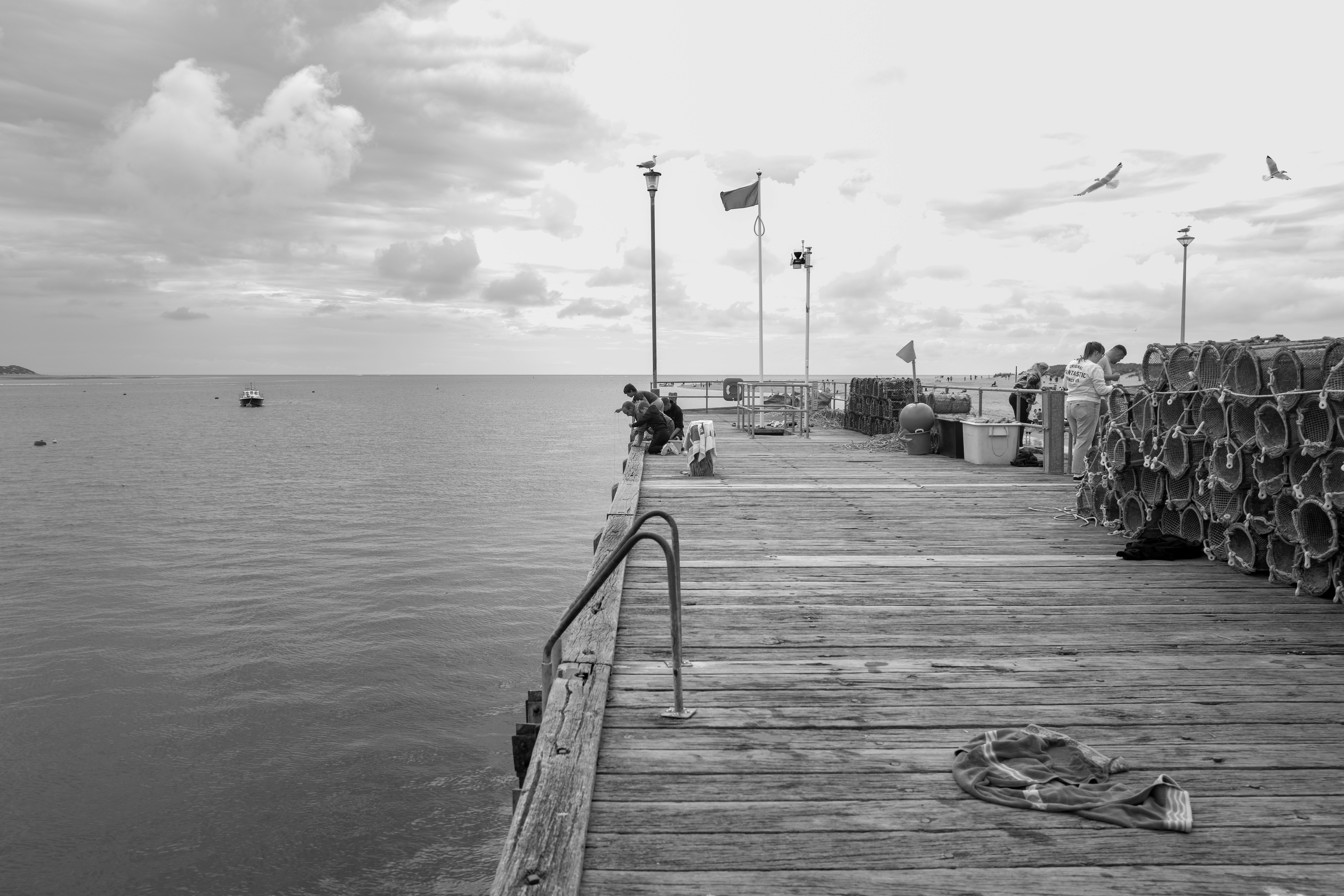 A black and white photo of a pier