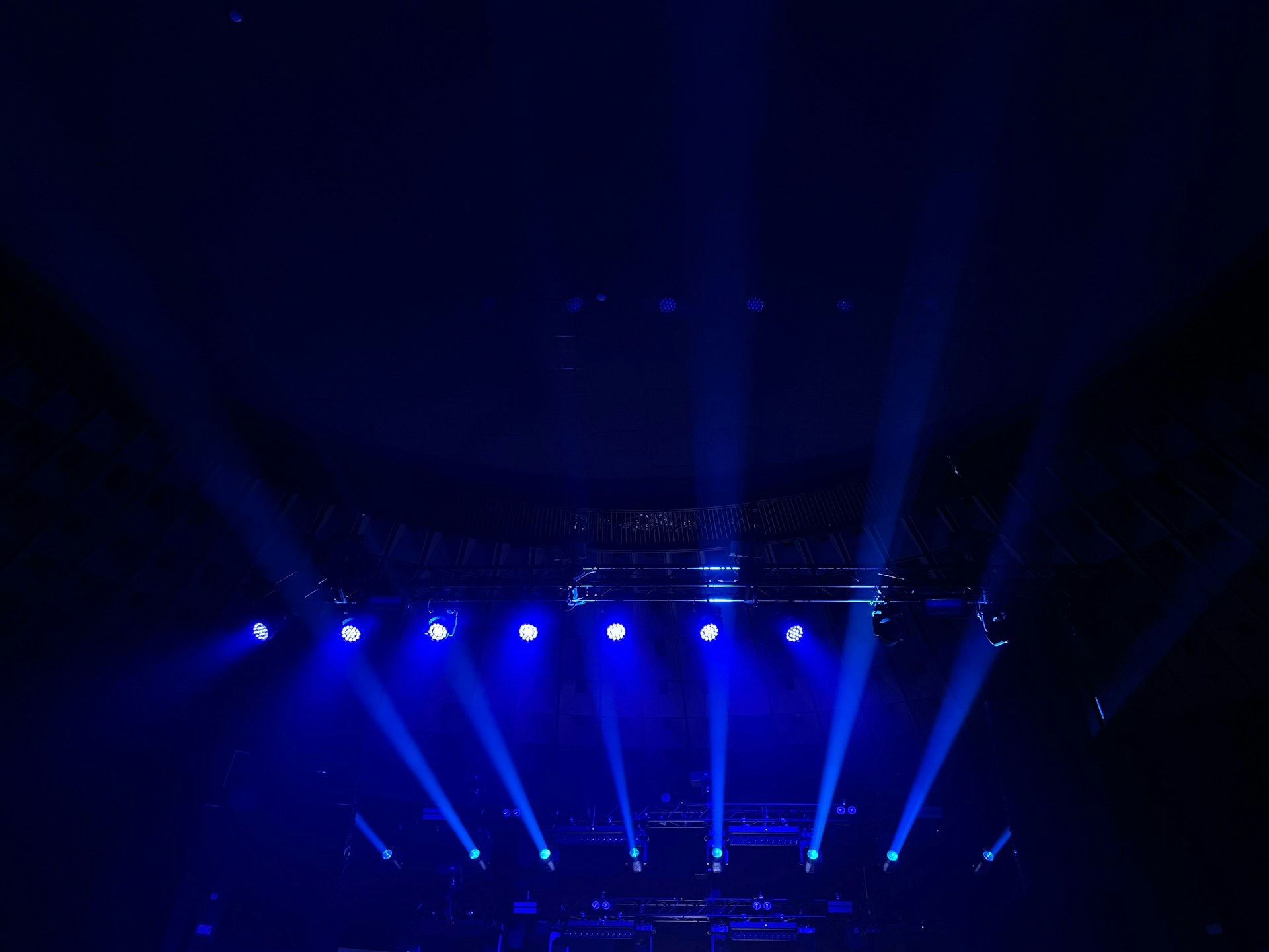 A group of people on a stage with blue lights
