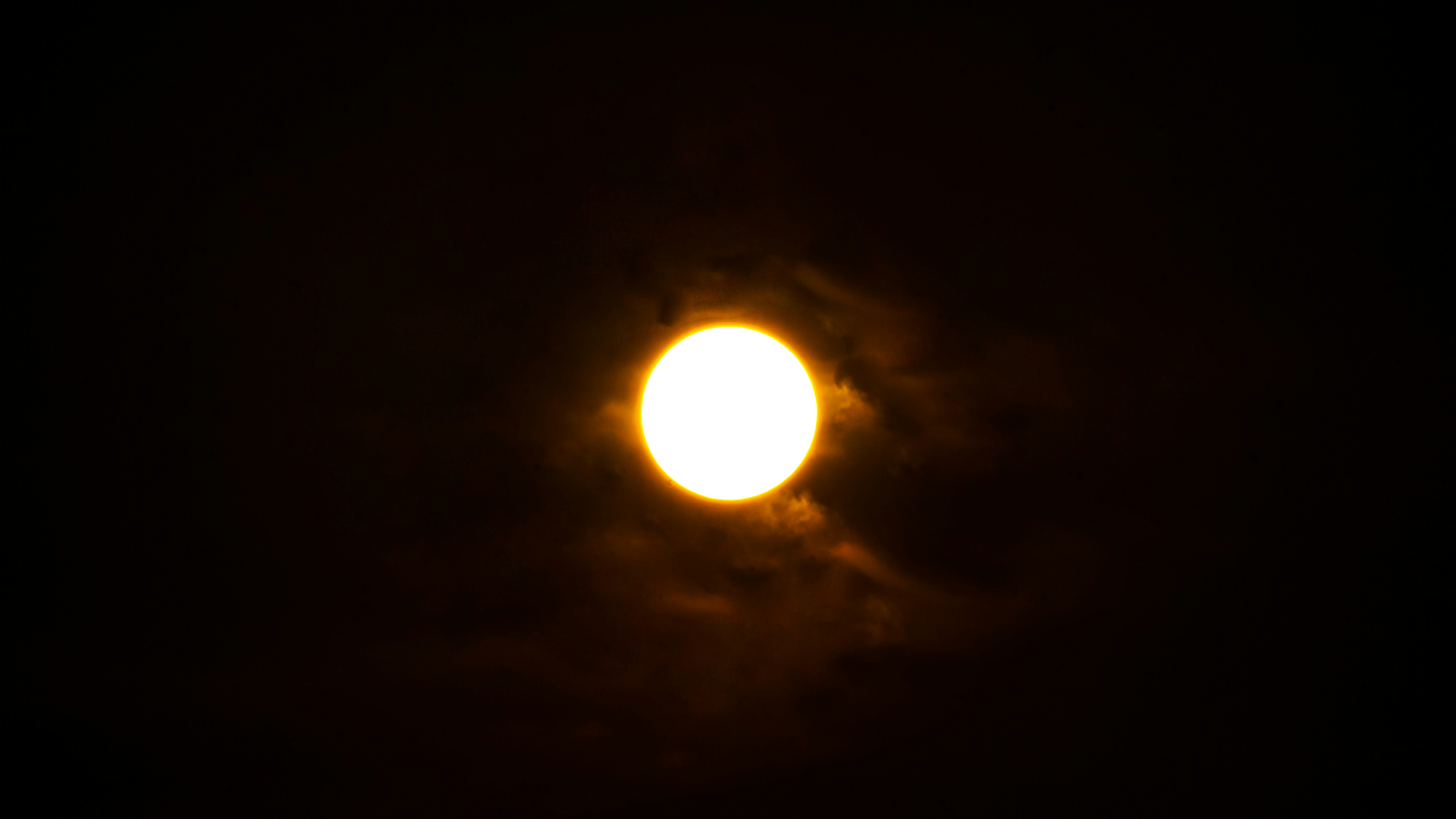 A bright light shines in the dark sky