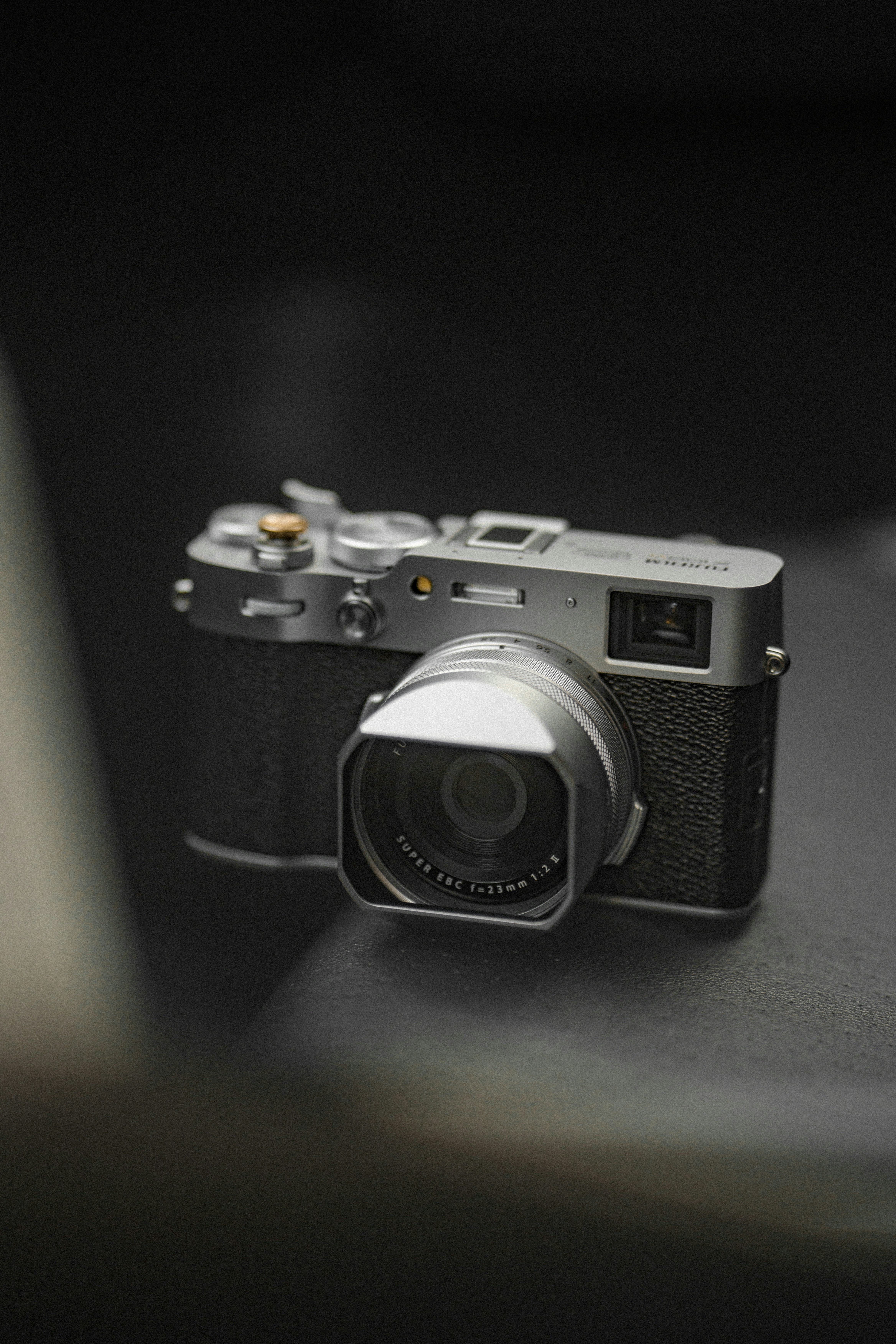 A camera sitting on top of a table next to a laptop