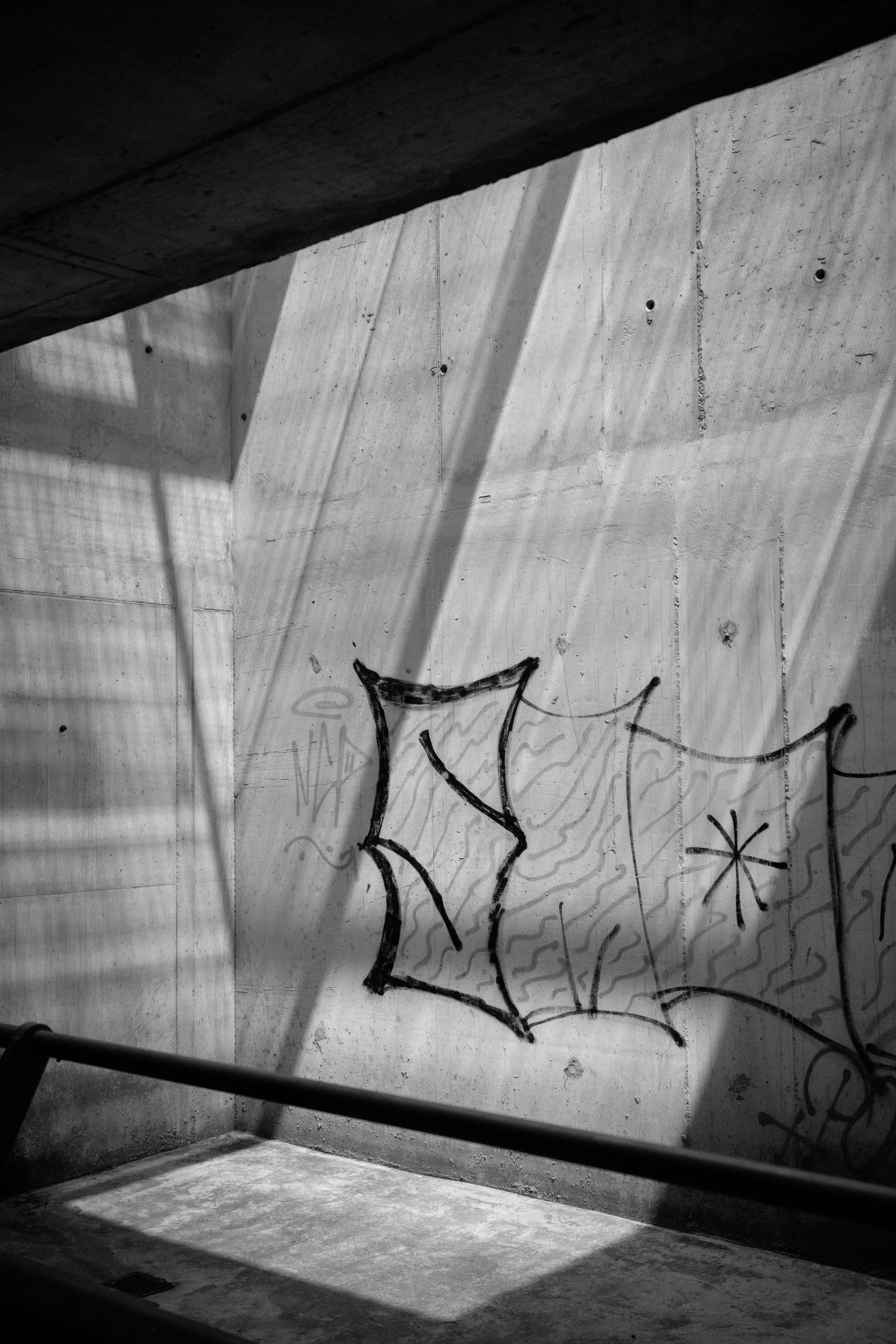 A black and white photo of graffiti on a wall