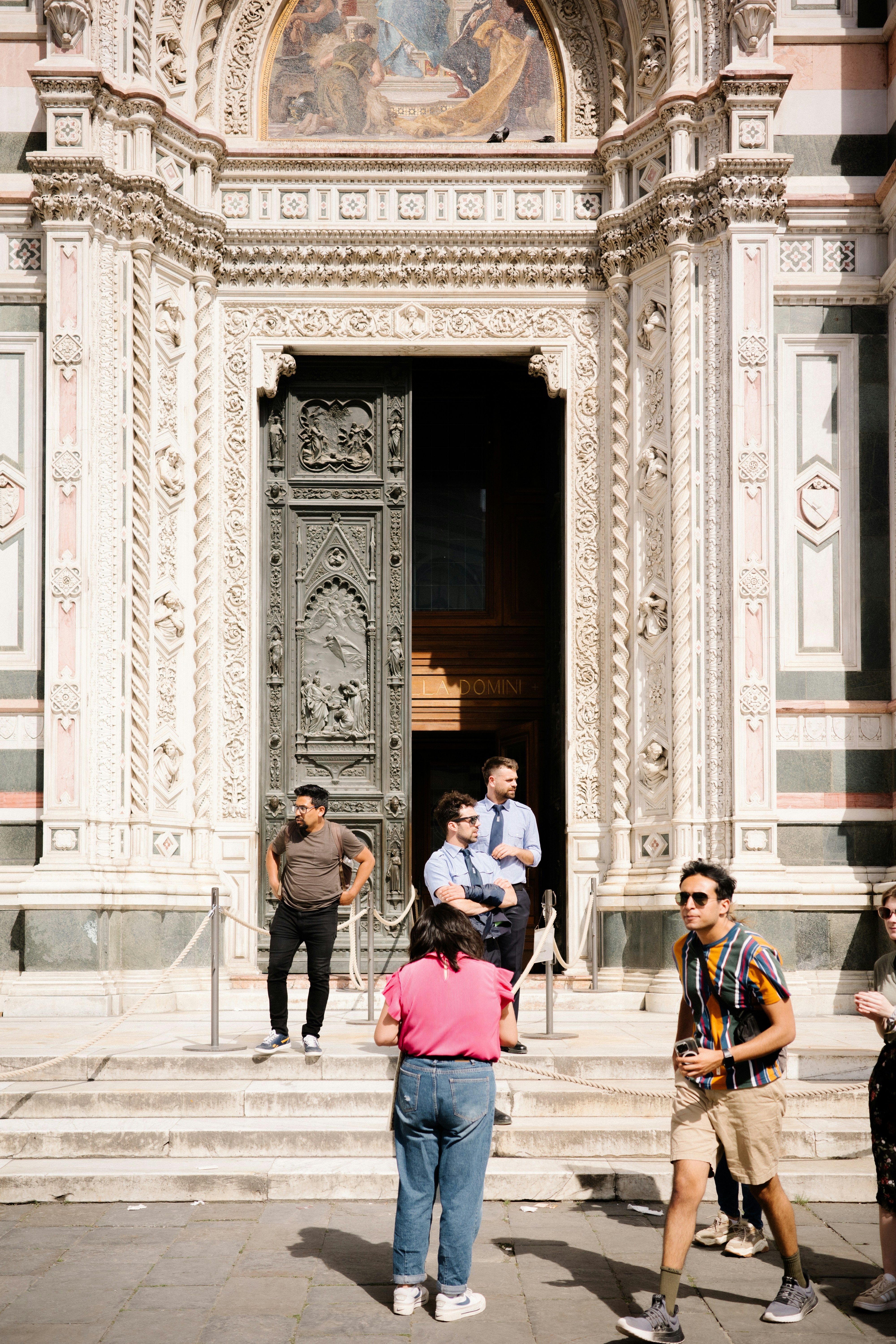 A group of people standing in front of a building