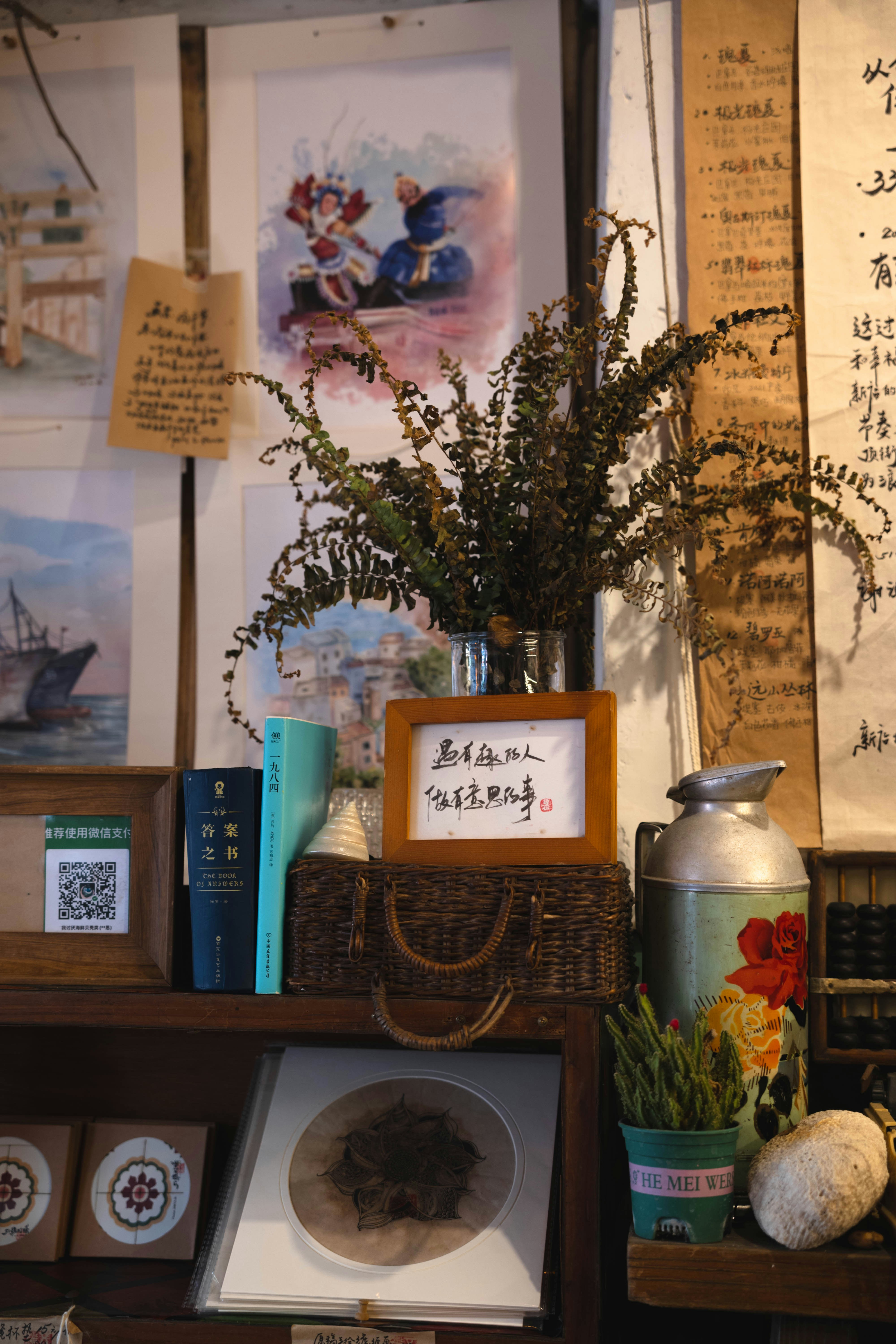 A shelf filled with lots of books and pictures