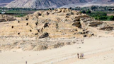 A group of people standing on top of a sandy beach