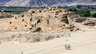 A group of people standing on top of a sandy beach