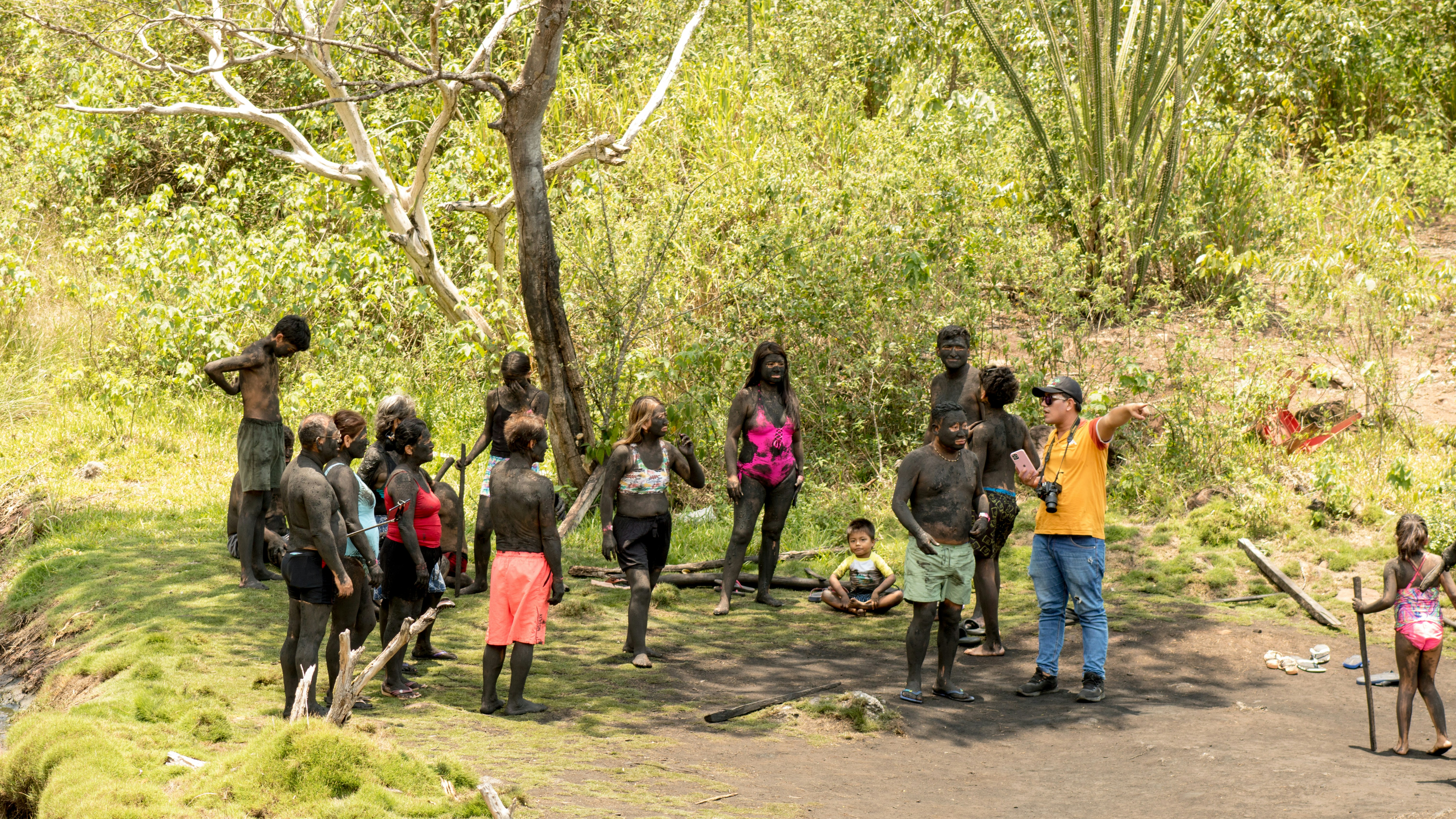 A group of people standing on the side of a road