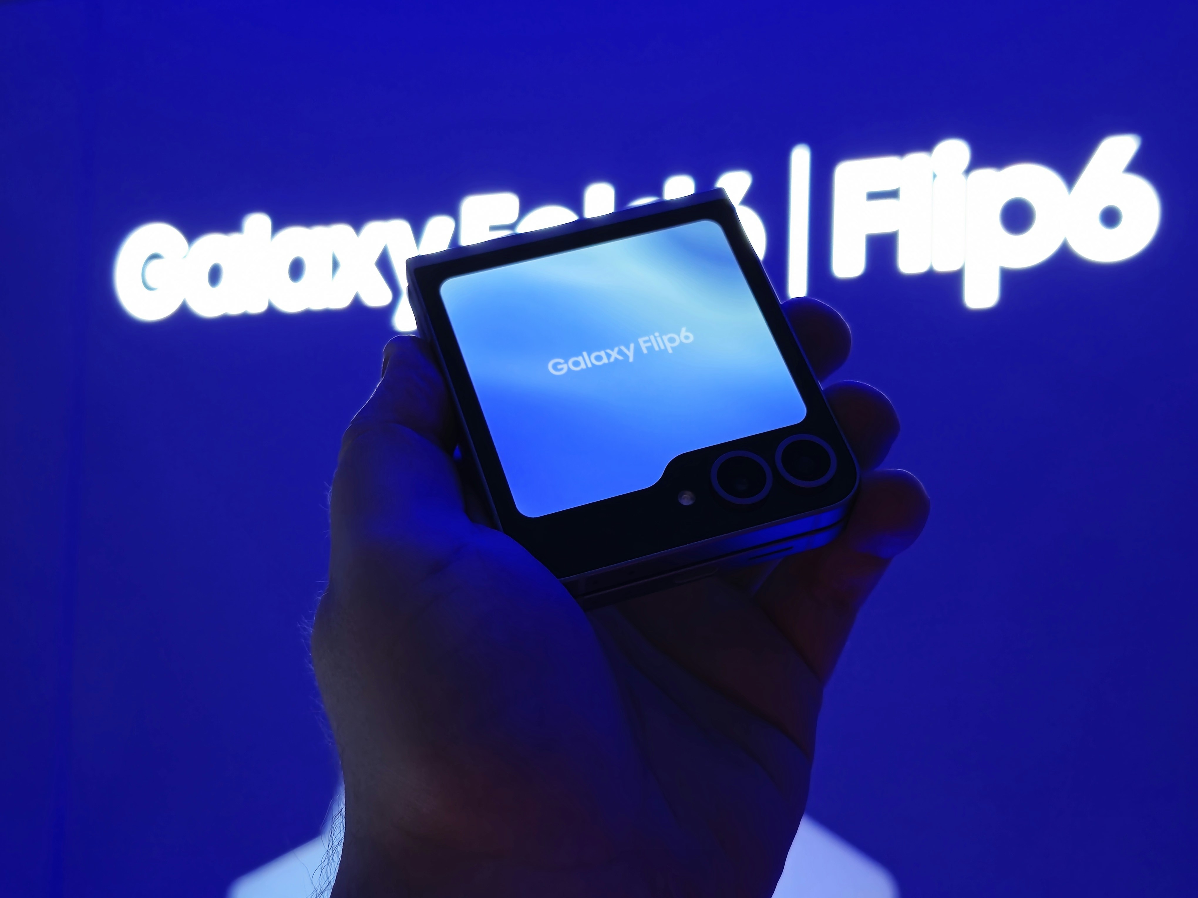 A person holding a smart phone in their hand