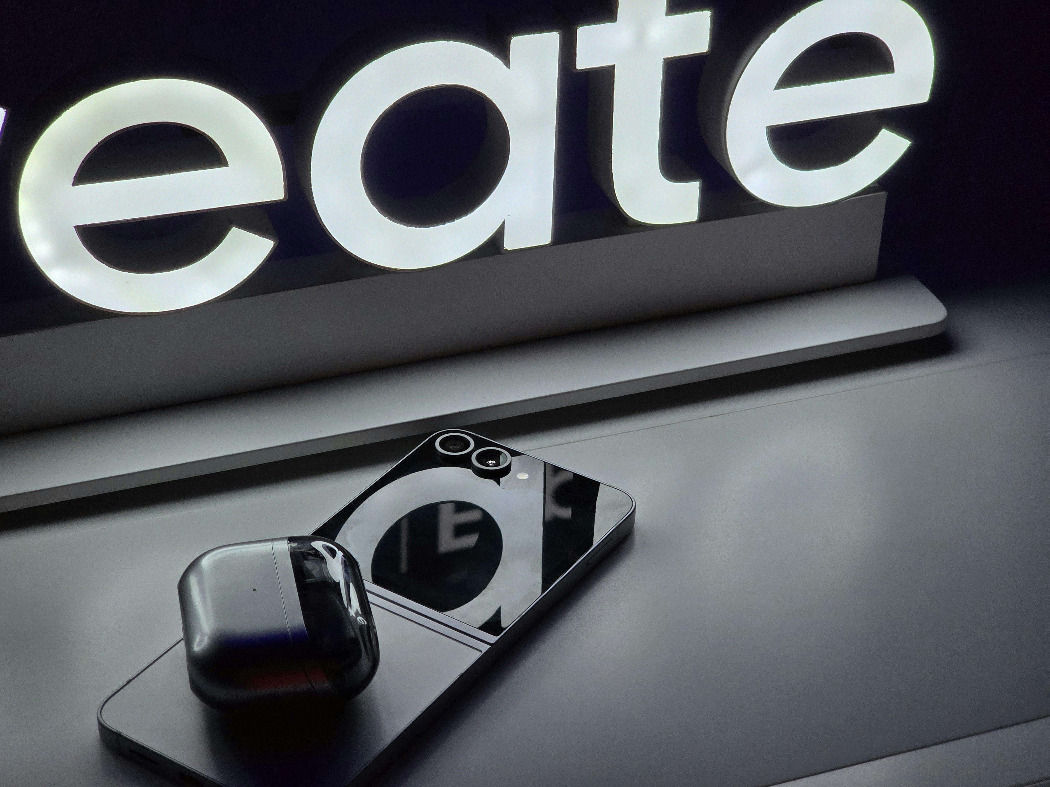 A close up of a cell phone near a sign