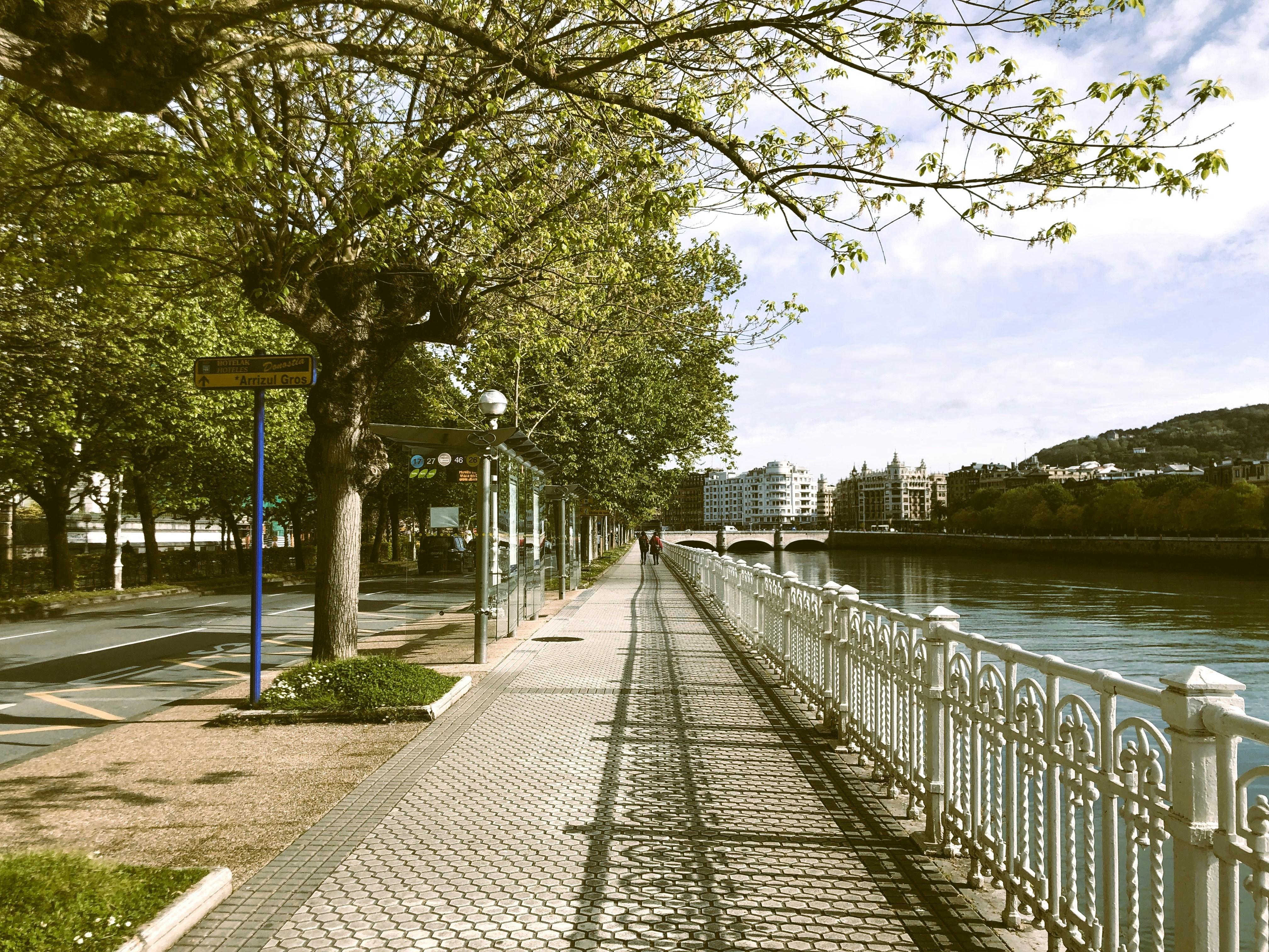A sidewalk next to a body of water