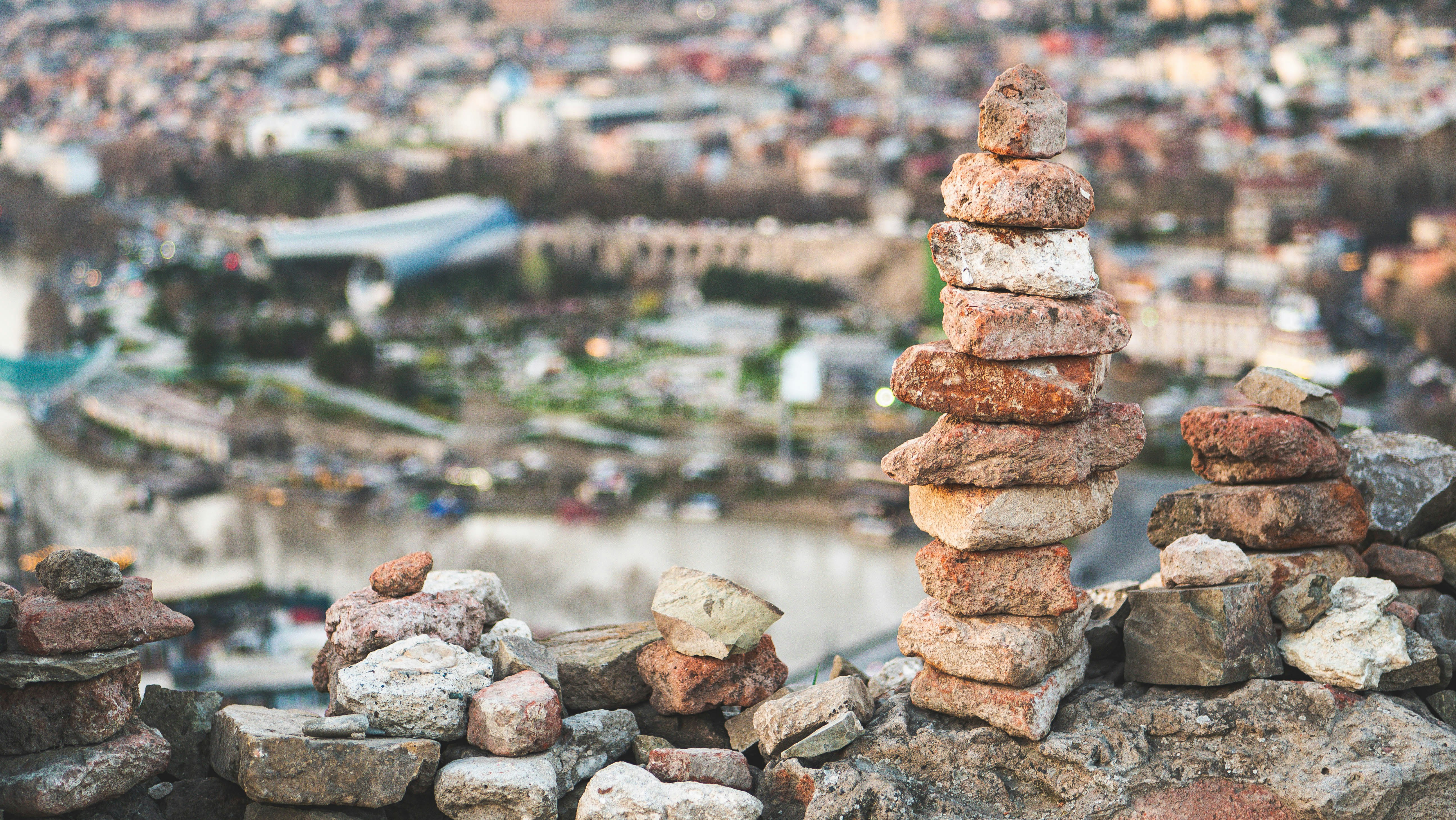 A pile of rocks with a city in the background