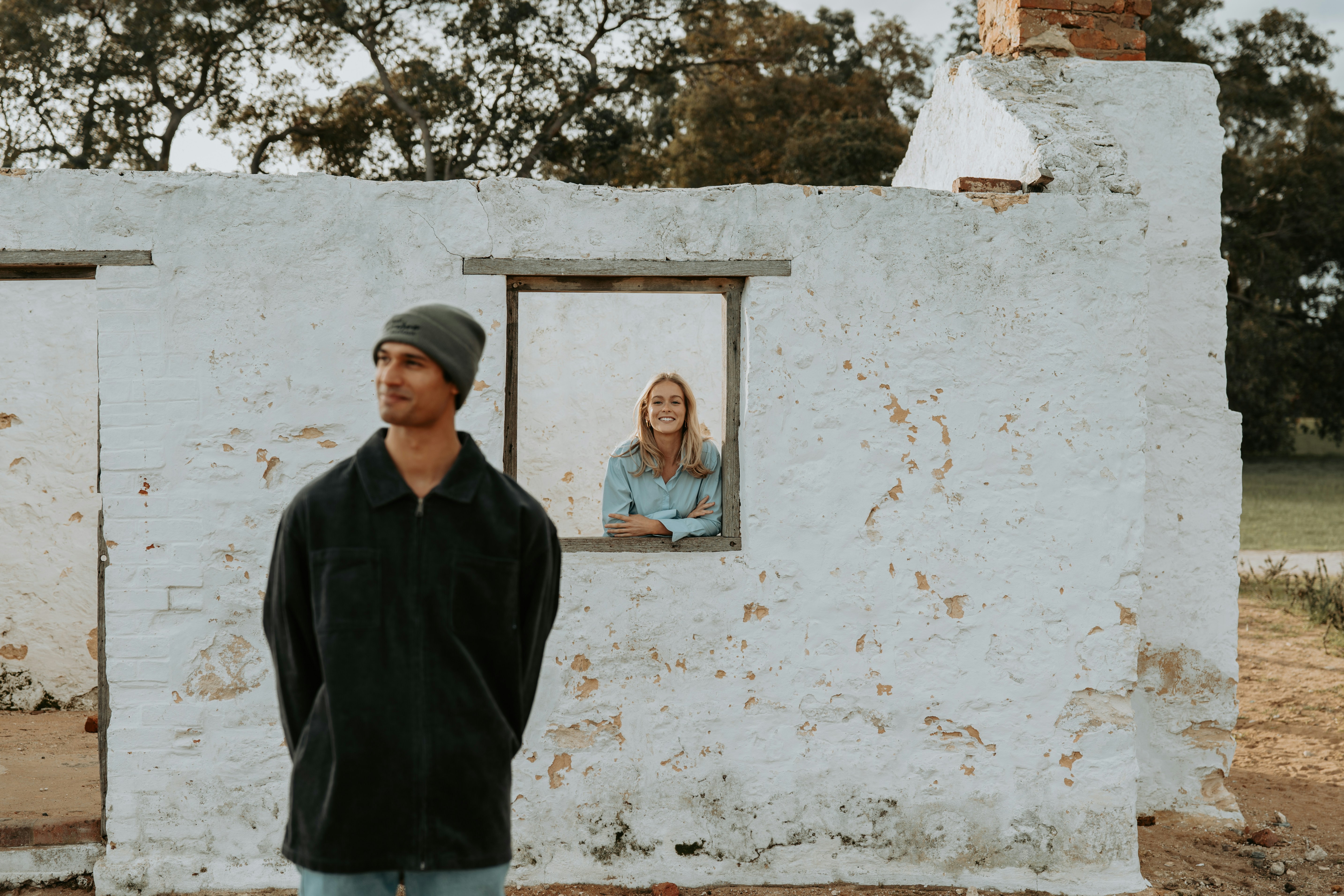 A man standing in front of a white building