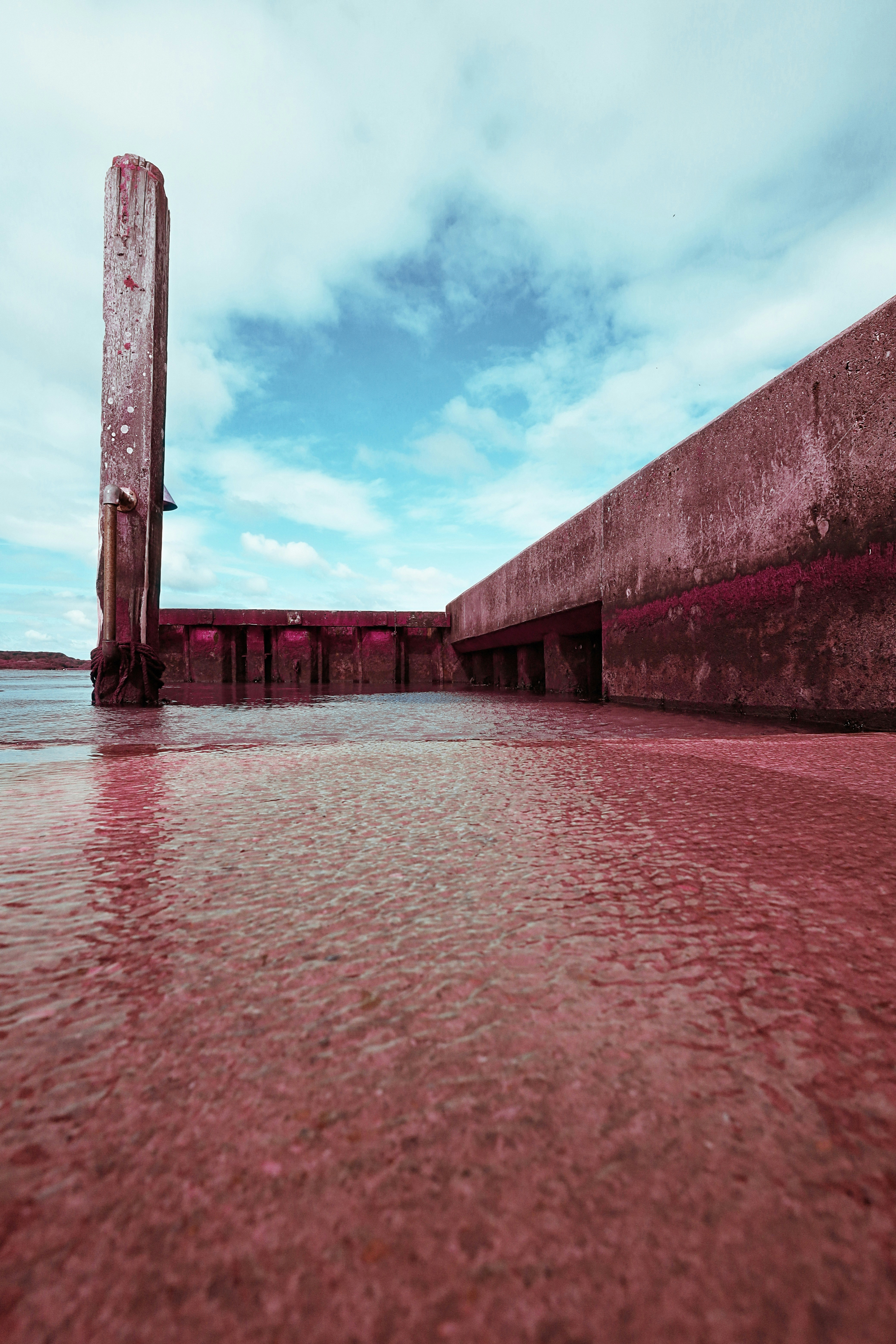 A large body of water next to a concrete wall
