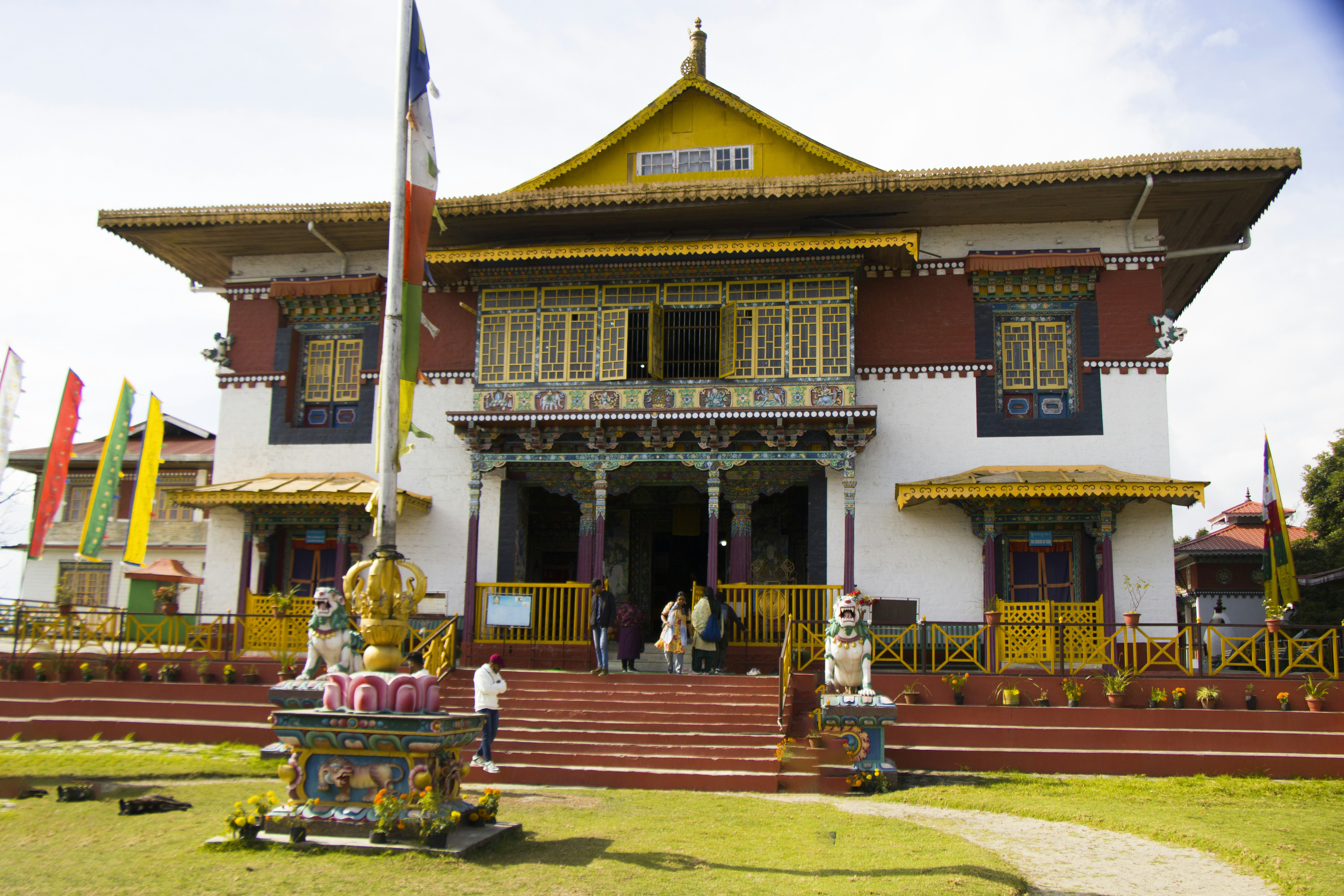 A large building with many flags flying in front of it, 