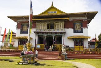 A large building with many flags flying in front of it