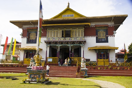 A large building with many flags flying in front of it