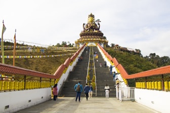 A group of people walking across a bridge