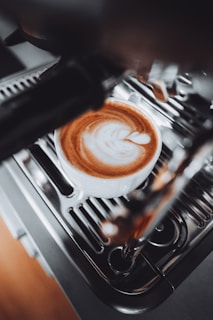 A cup of coffee sitting on top of a stove