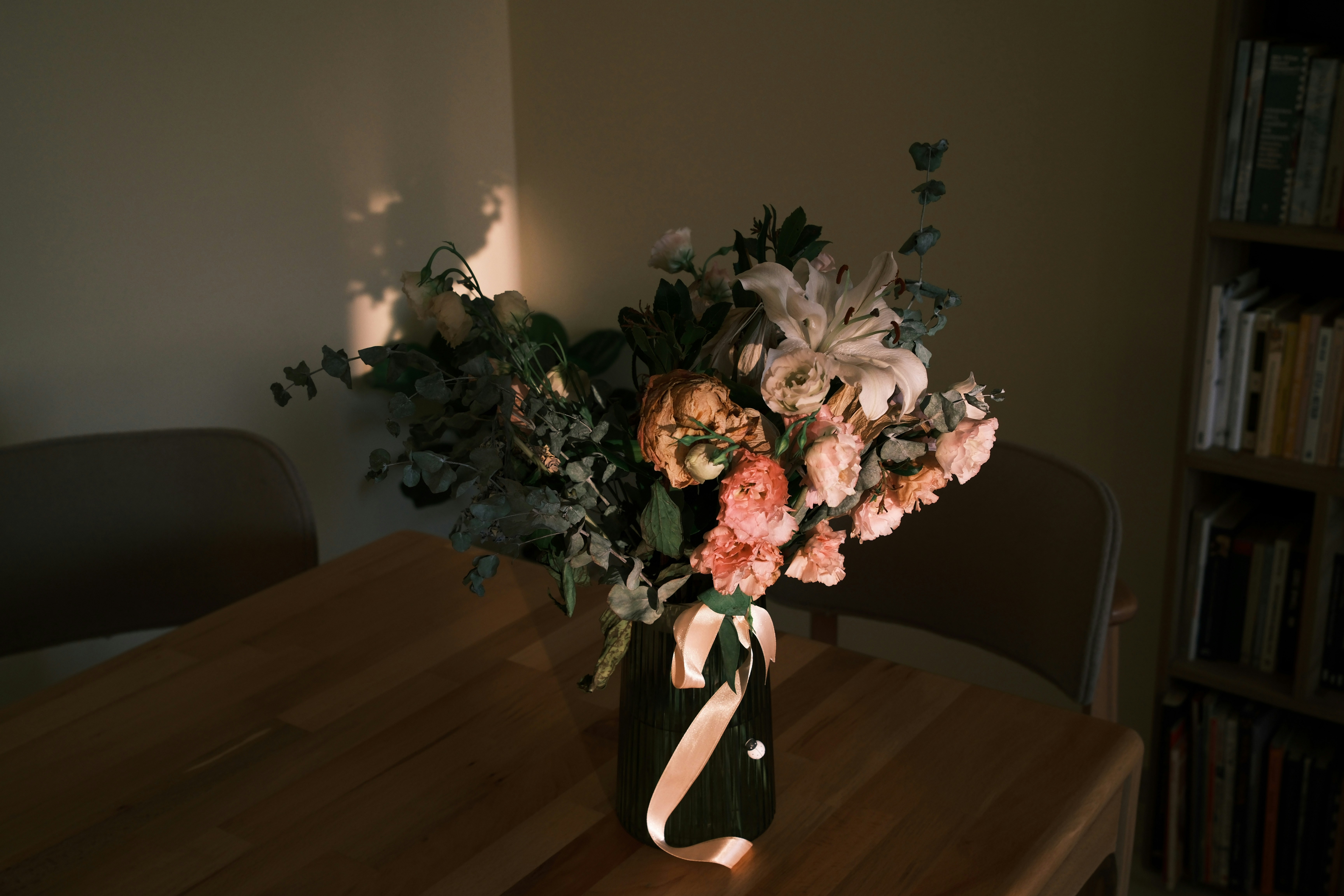 A vase of flowers sitting on top of a wooden table