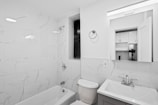 A bathroom with a toilet, sink, and bathtub