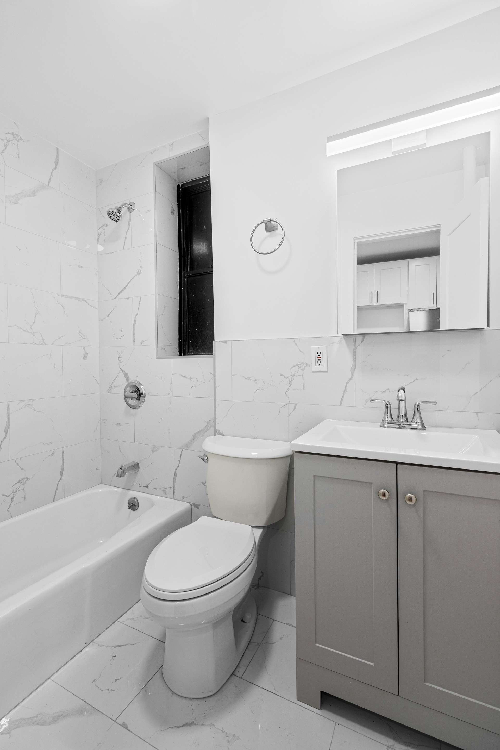 A bathroom with a toilet, sink, and bathtub