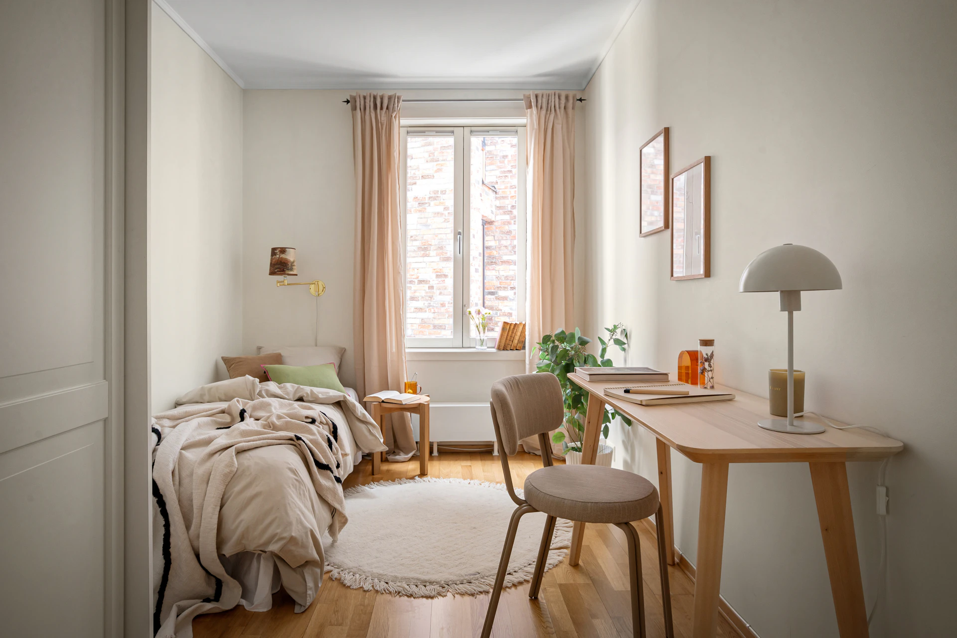 A bedroom with a bed, desk and chair