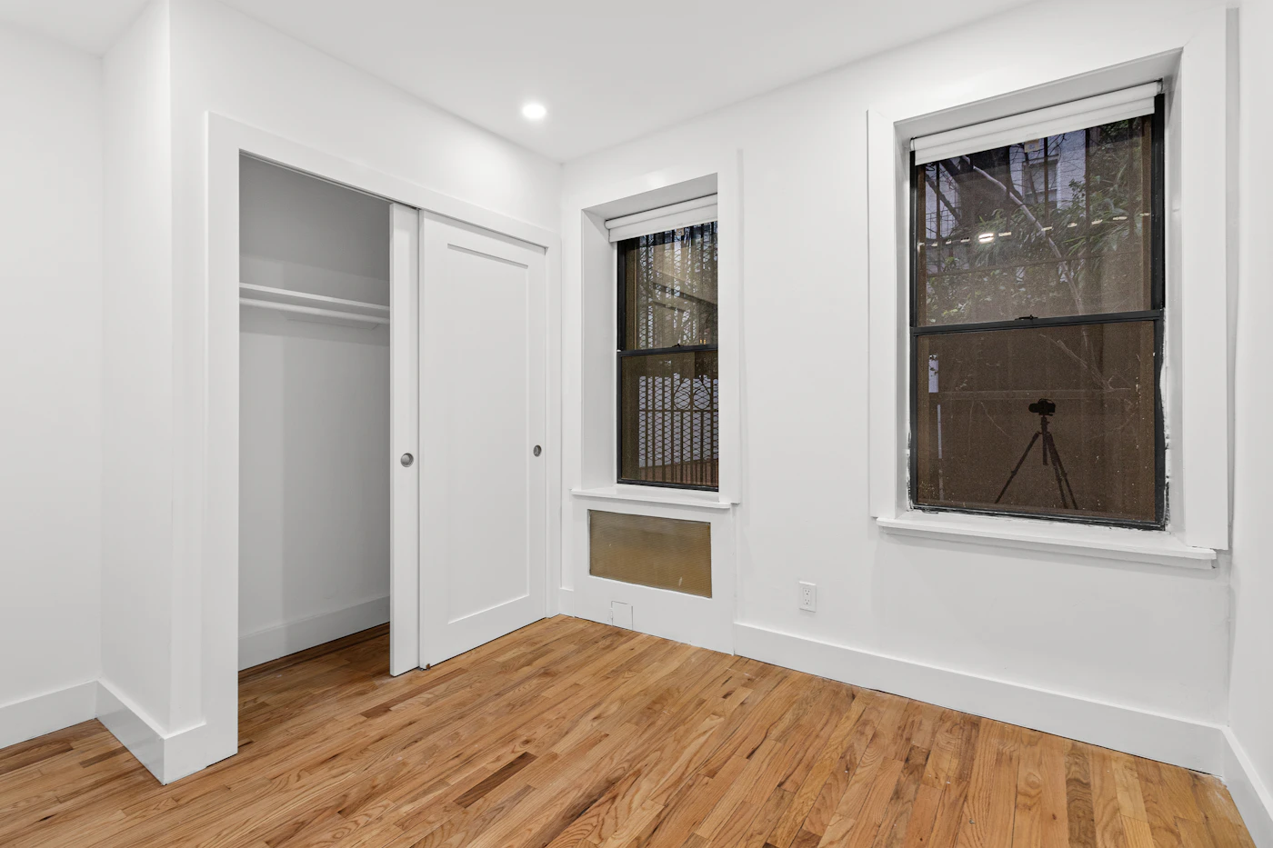 An empty room with white walls and wood floors, ready for inspection