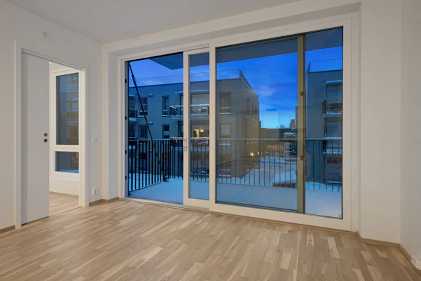 An empty room with a large sliding glass door