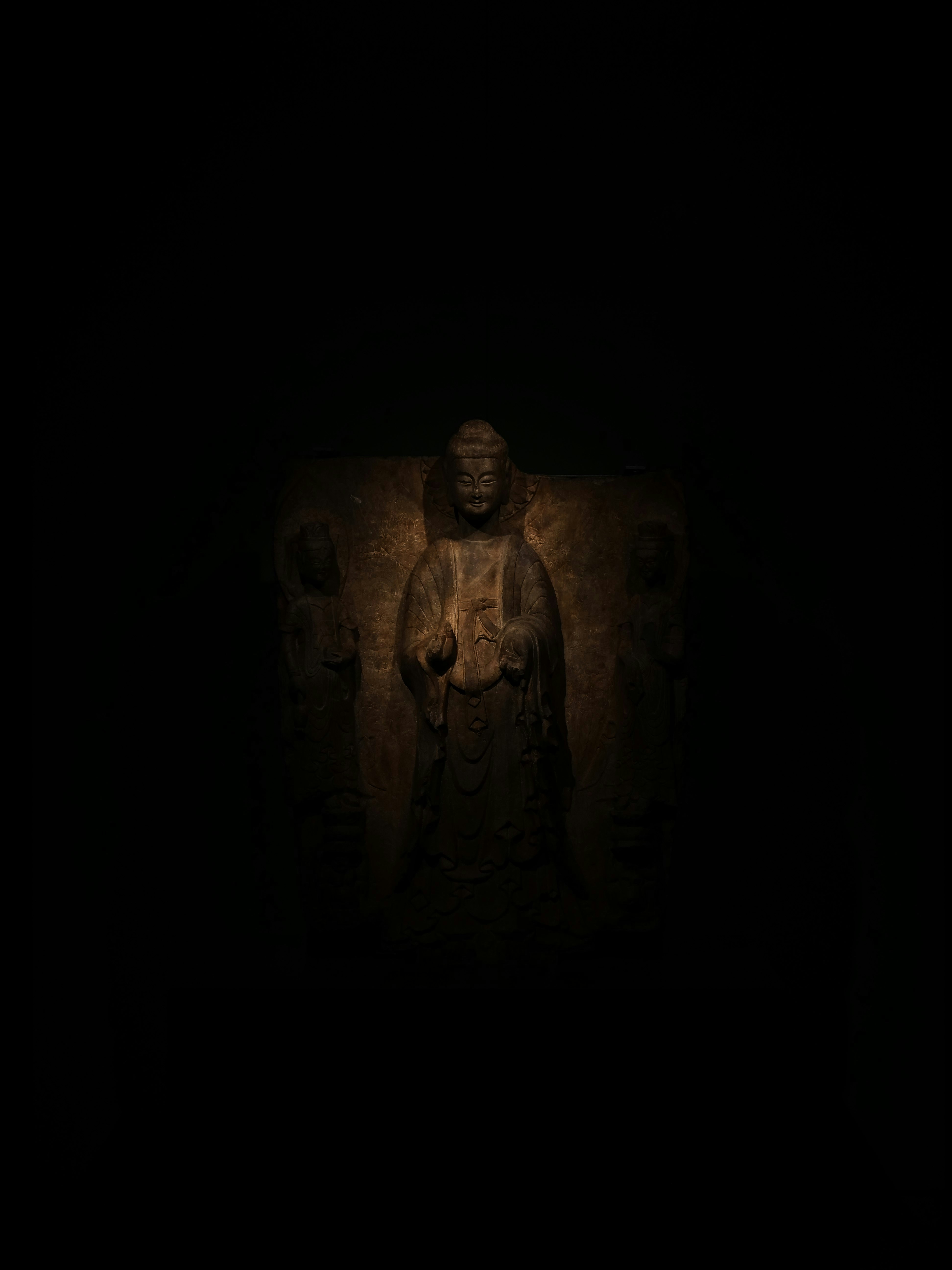 A statue of a person in the dark