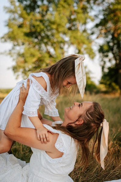 A woman holding a little girl in her arms
