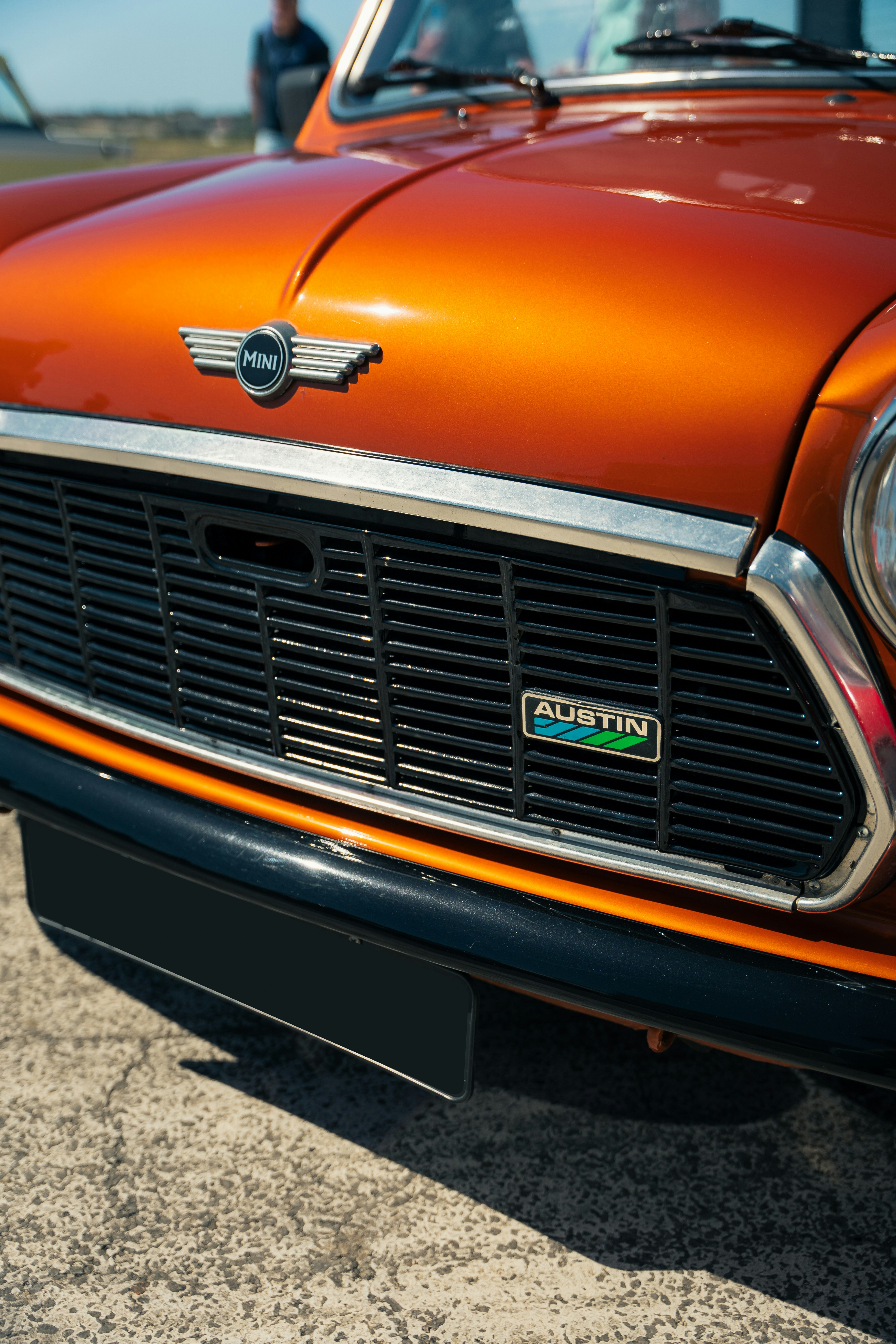An orange car parked on the side of the road