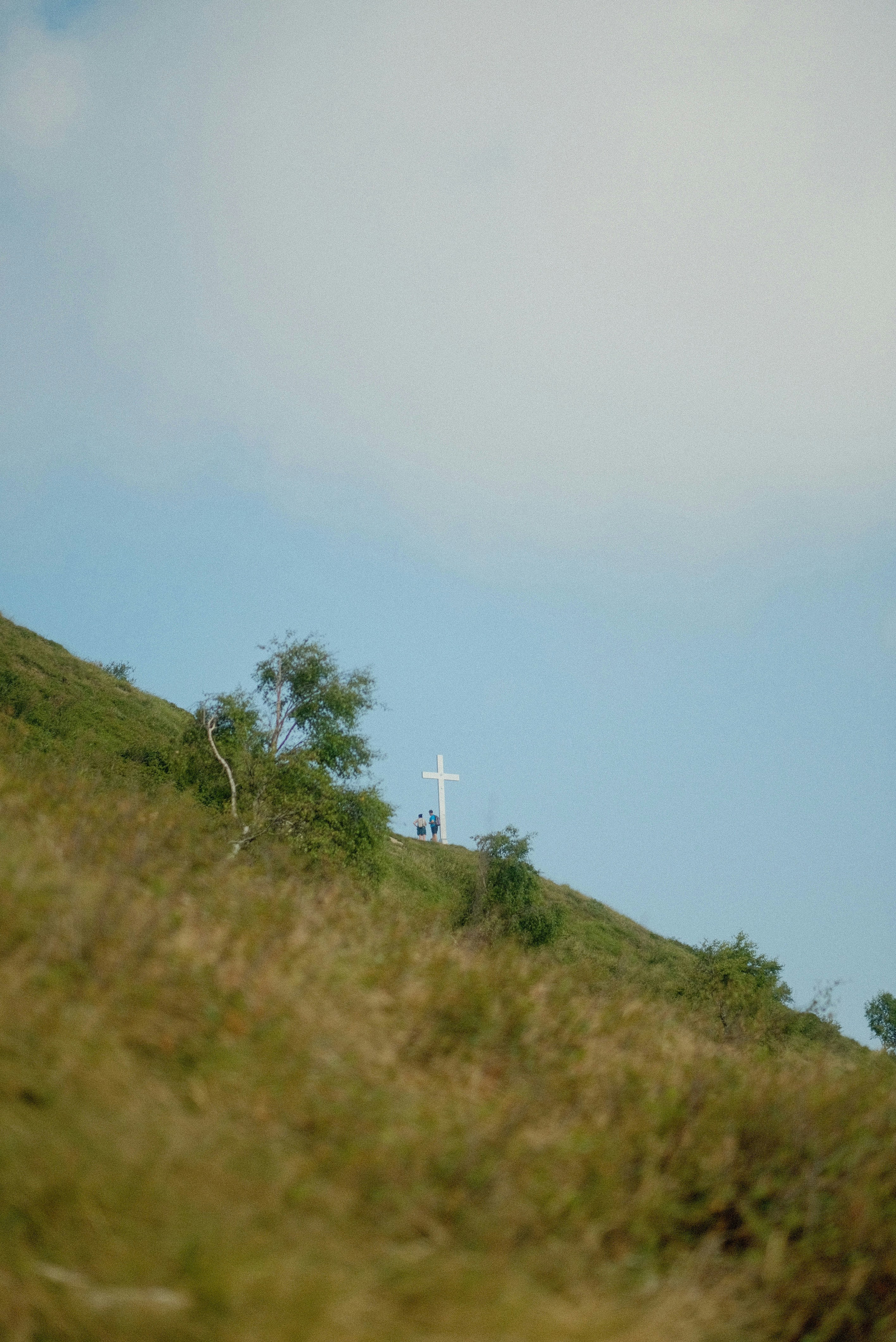 A hill with a cross on top of it