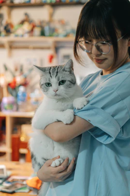 A woman holding a cat in her arms