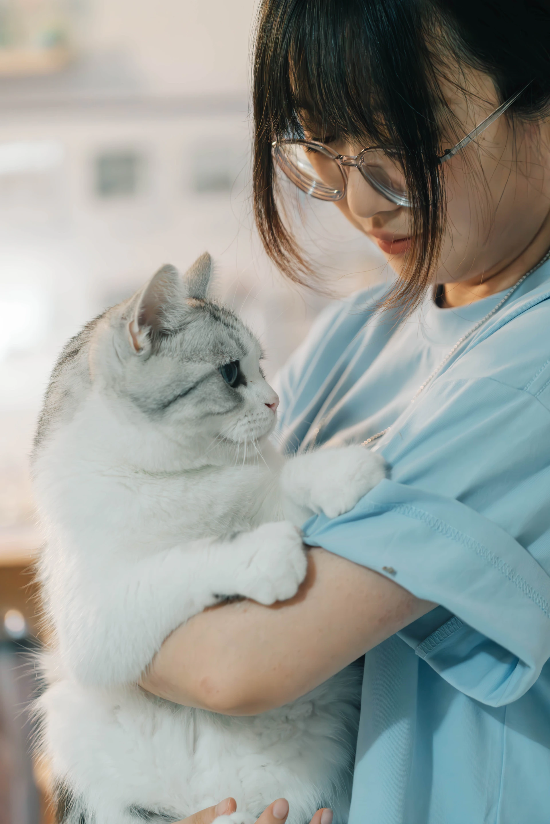 A woman holding a cat in her arms