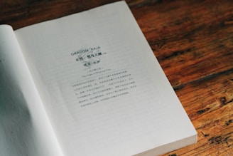 An open book sitting on top of a wooden table