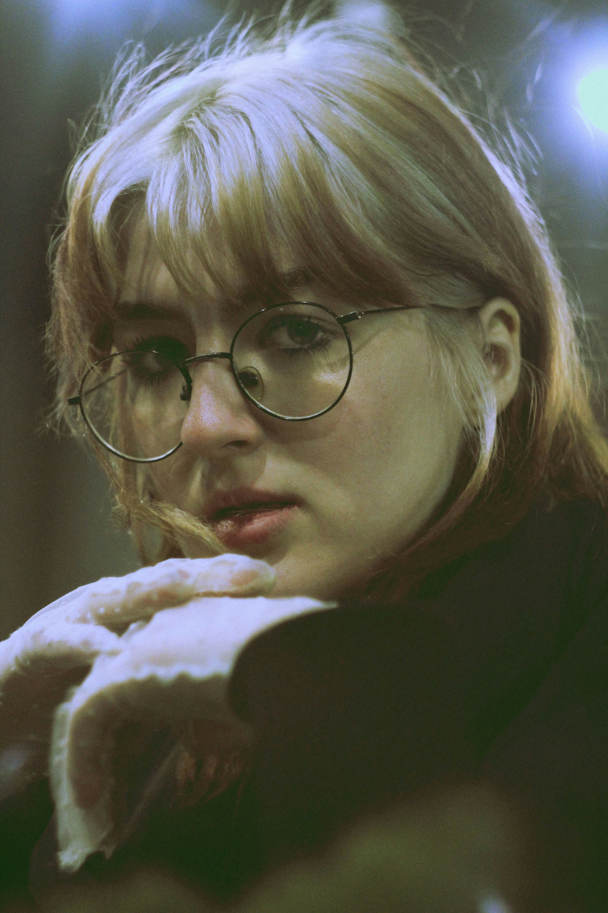 A woman with glasses is looking at something