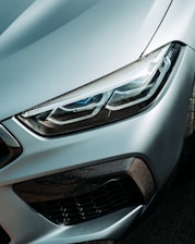 A close up of the front of a silver car