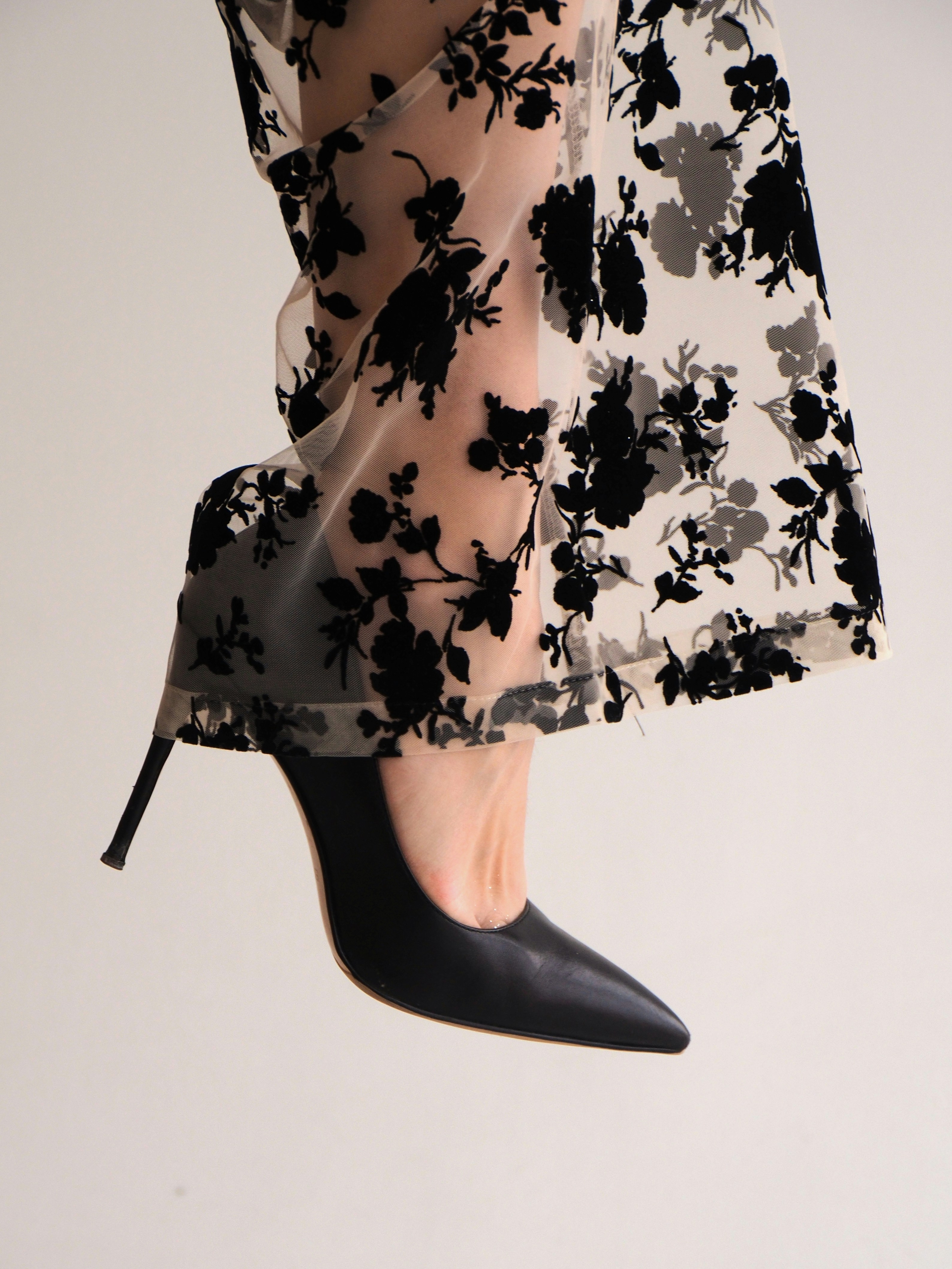 A close up of a woman's legs wearing high heels