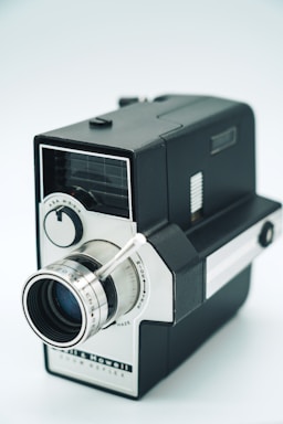 A black and white camera on a white background