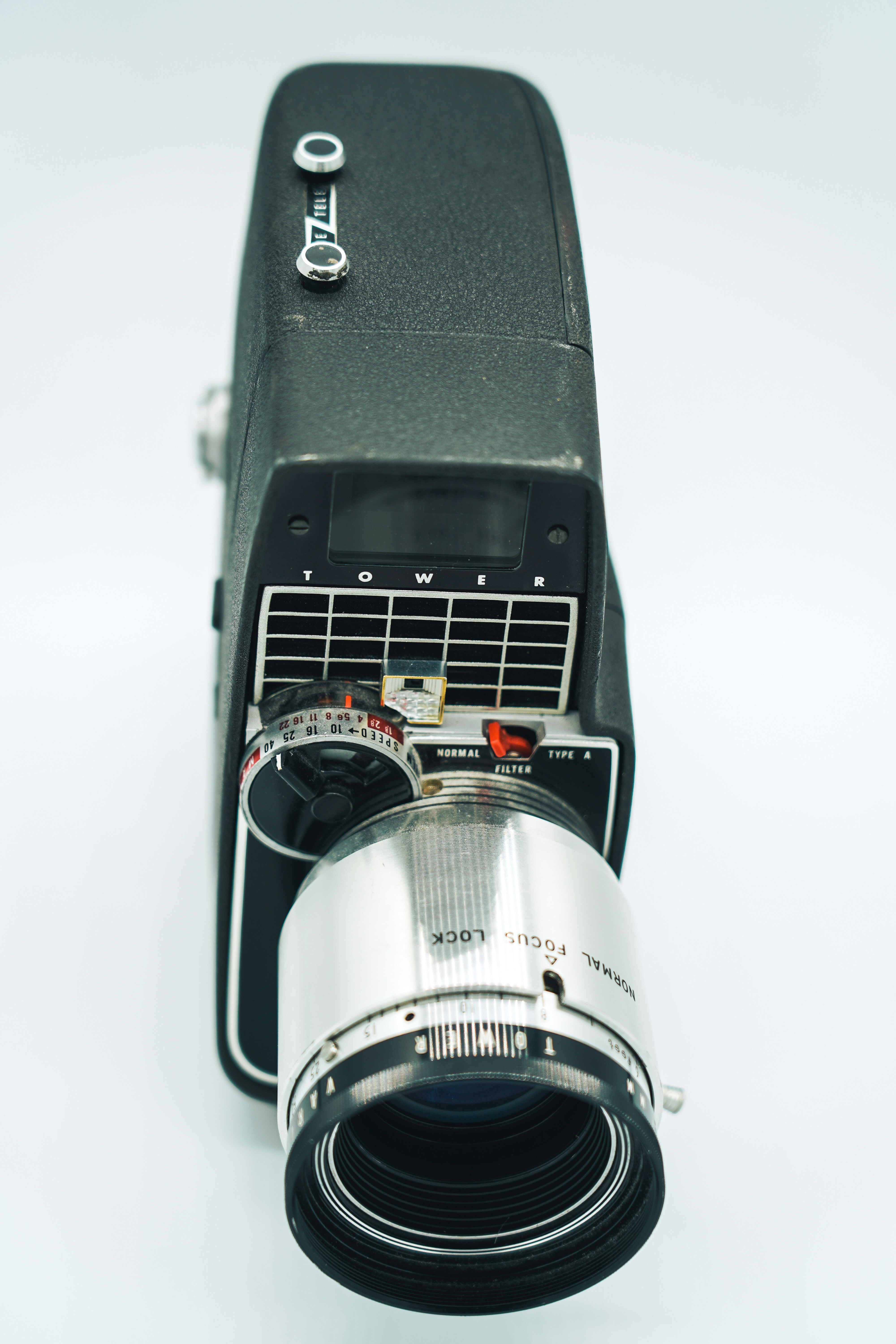 A close up of a camera on a white surface