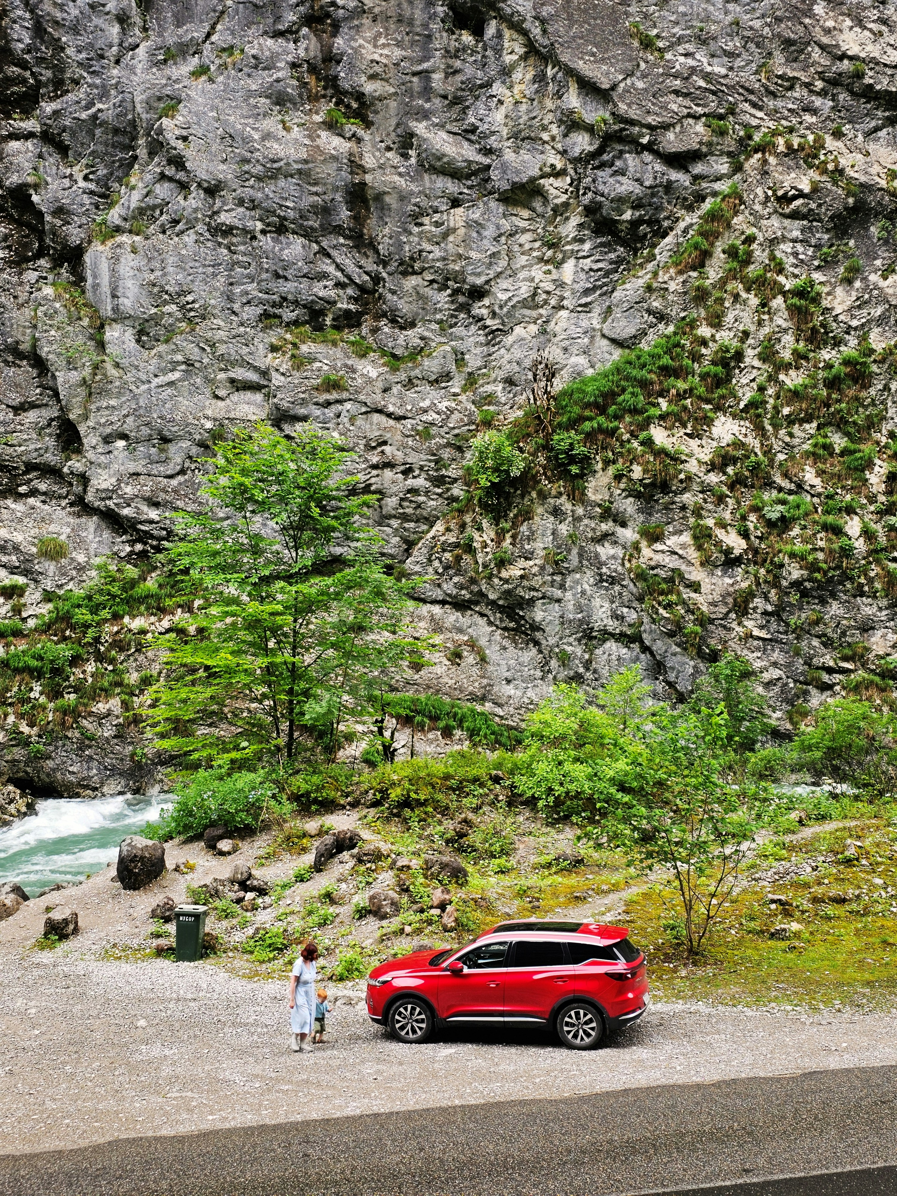 A red car parked on the side of a mountain road photo – Free Abkhazia ...