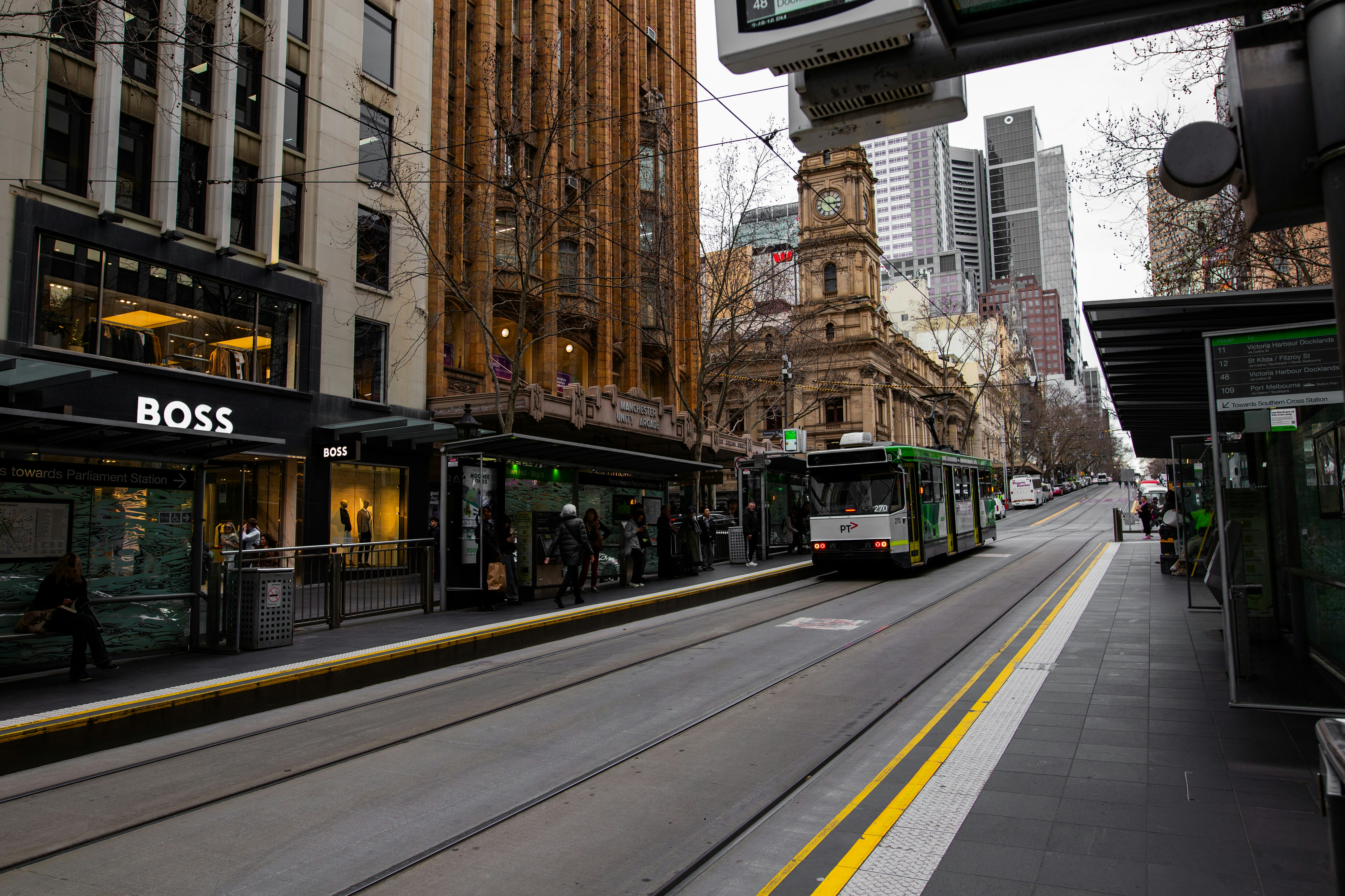 A city street filled with lots of traffic next to tall buildings