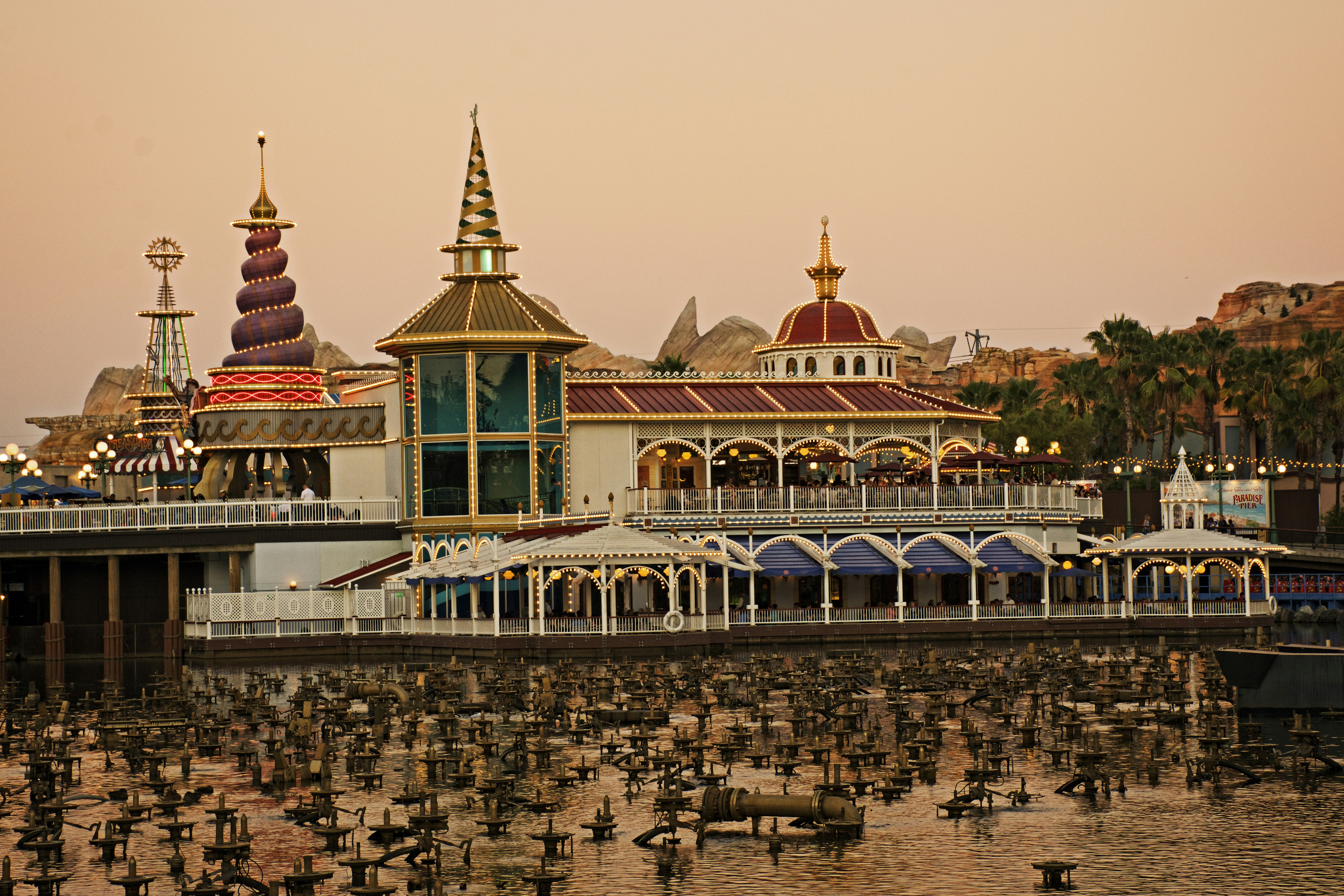 A pier with a bunch of birds in the water