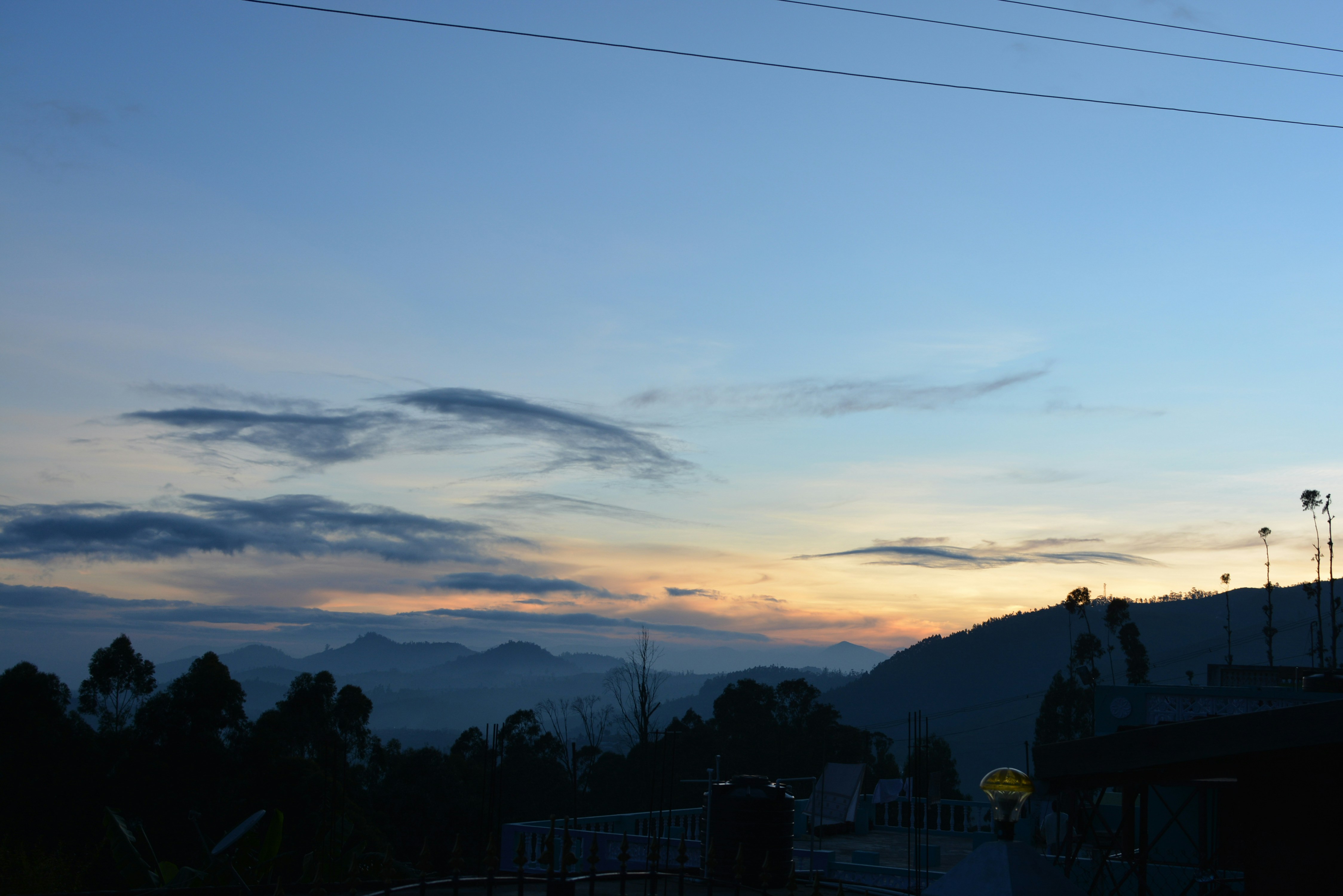 A view of the sky at dusk from a parking lot