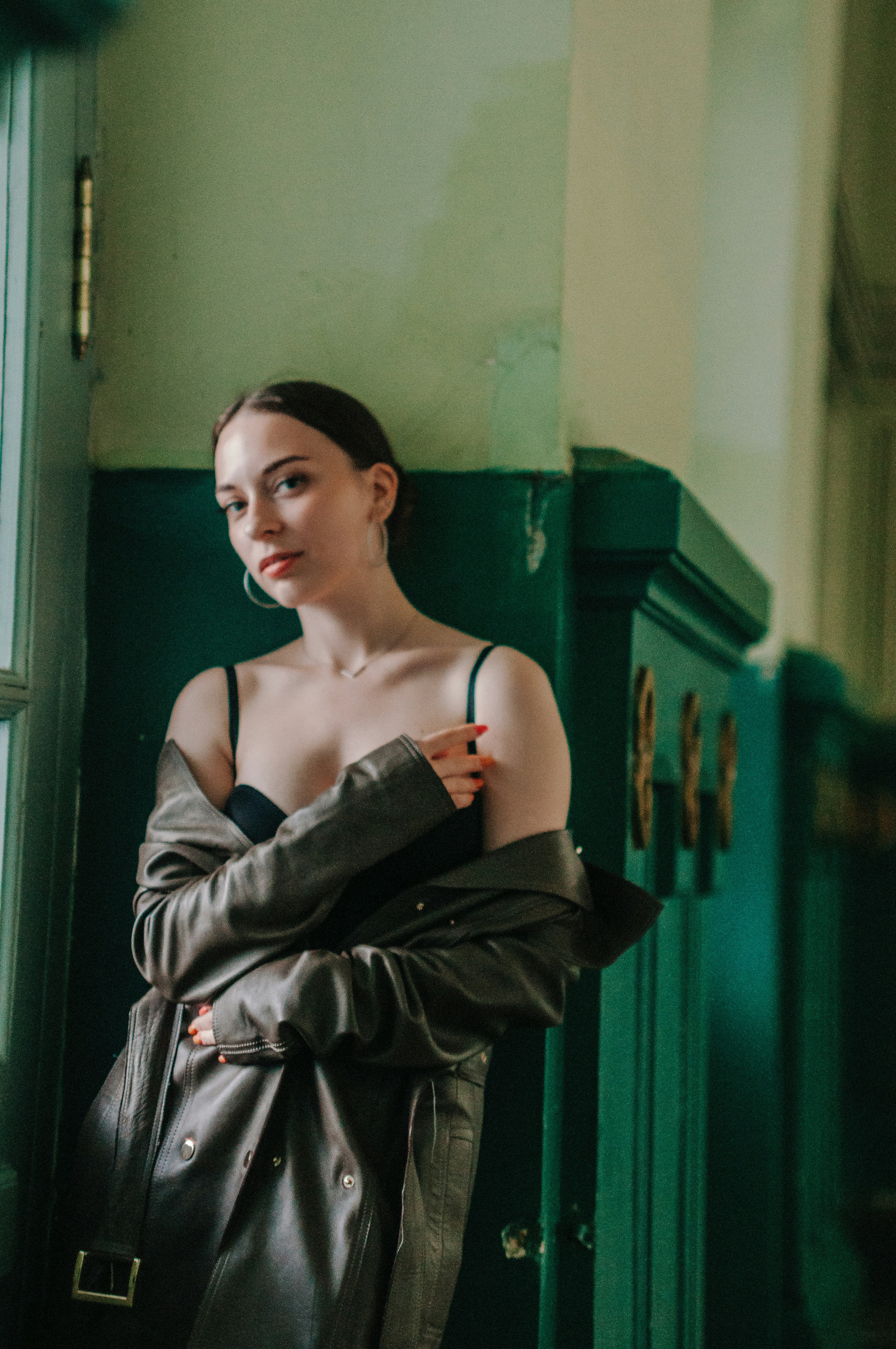 A woman standing next to a window in a room